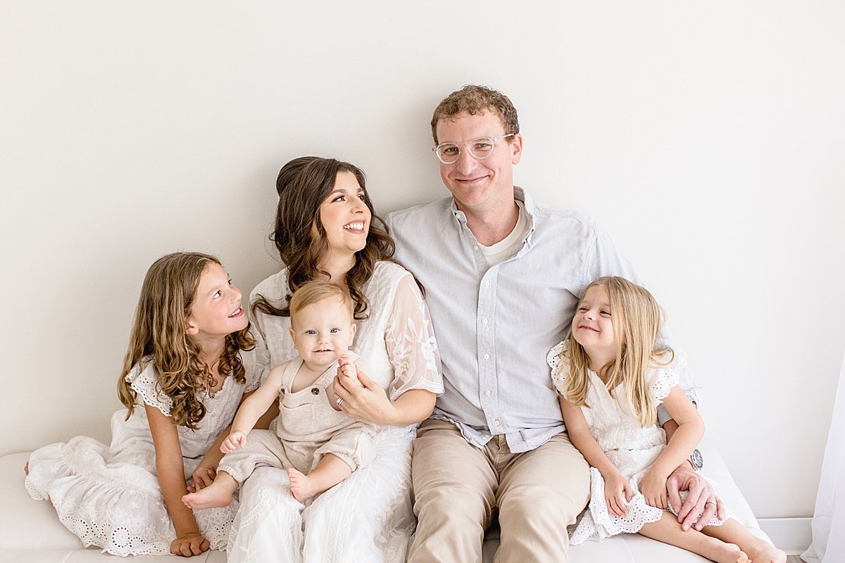 Candid laughing family portrait during first year session with Ambre Williams Photography in Newport Beach studio