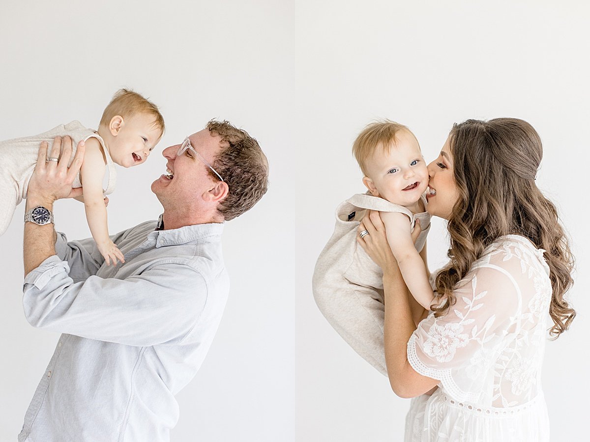 Mom and Dad holding baby candid portrait | Ambre Williams Photography in Newport Beach Studio