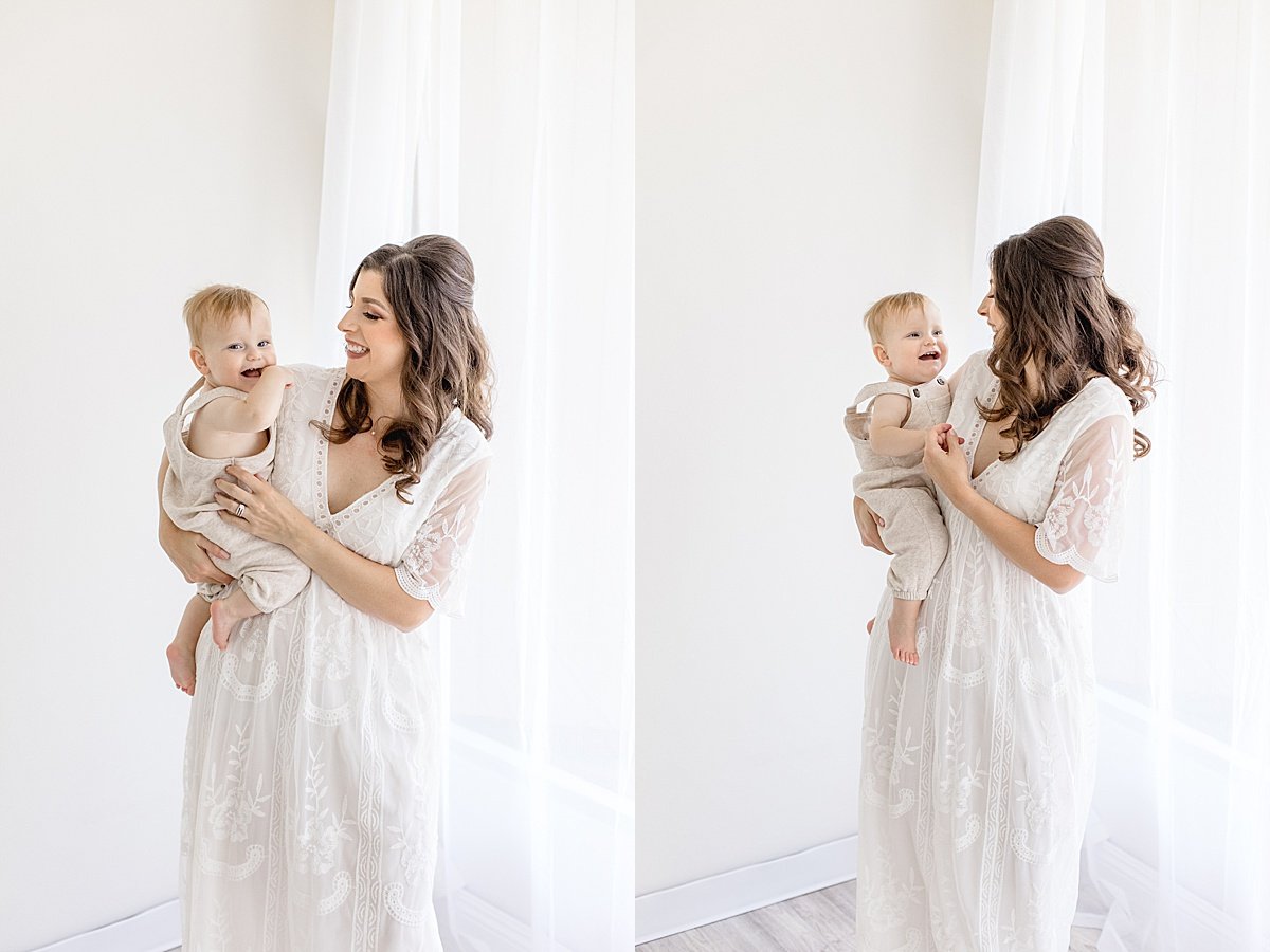 Candid portraits of mom and son during first year portrait session in Newport Beach studio near window natural lighting with Ambre Williams Photography