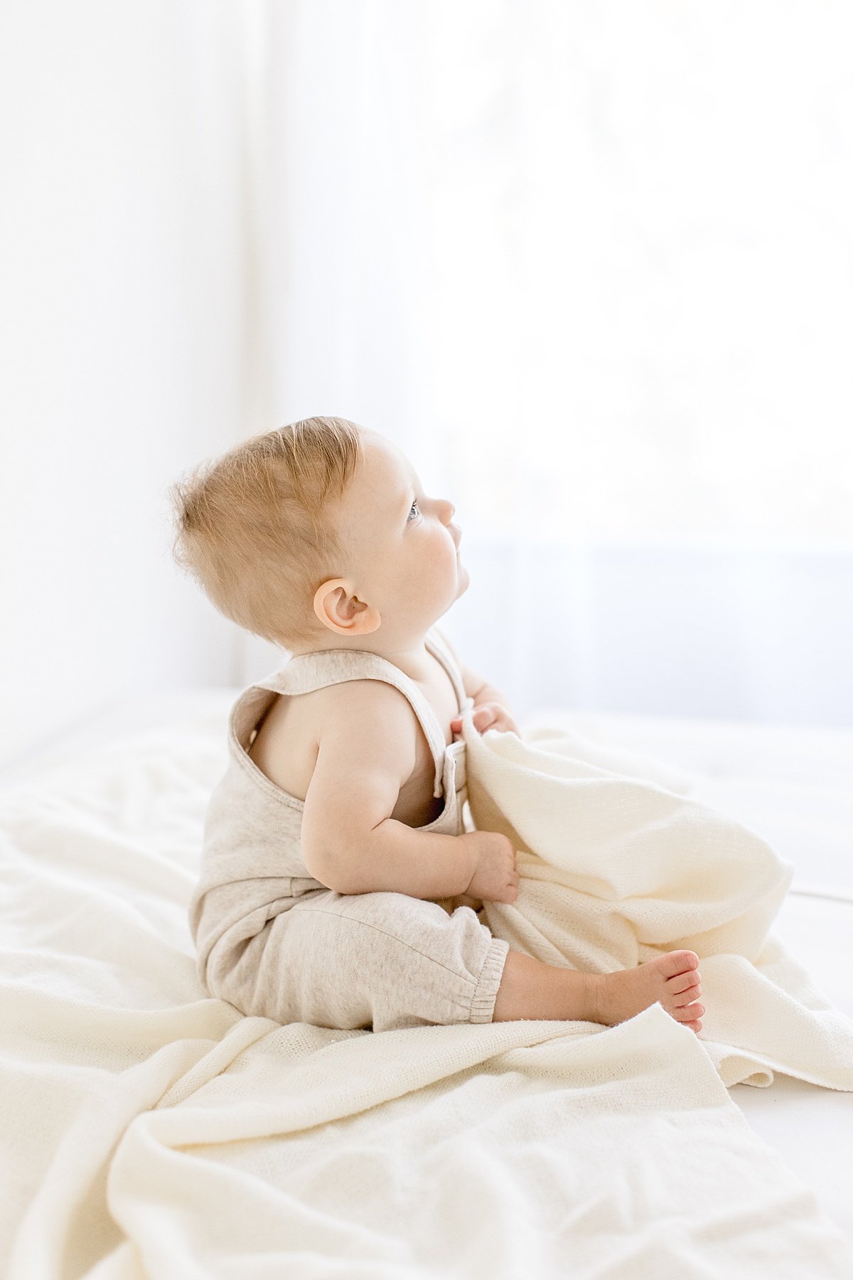 1 Year old portrait session with Ambre WIlliams Photography. Candid portrait of baby looking up in Newport Beach studio