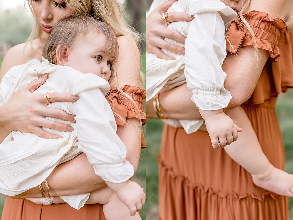 Momma holding tired daughter during outdoor portrait session with Ambre Williams Photography in Newport Beach Lake Forest California 