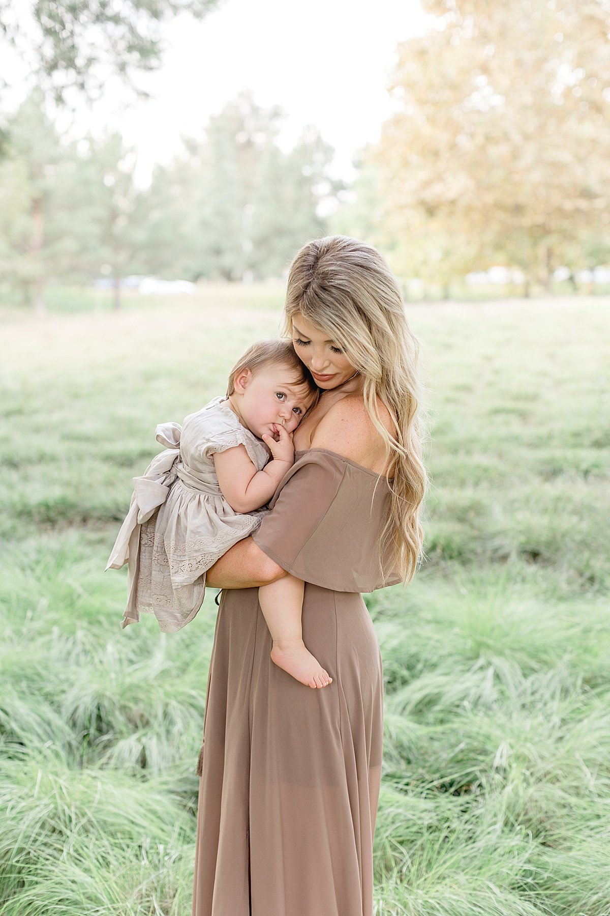 Beautiful Momma hugging daughter during portrait session with Ambre Williams Photography