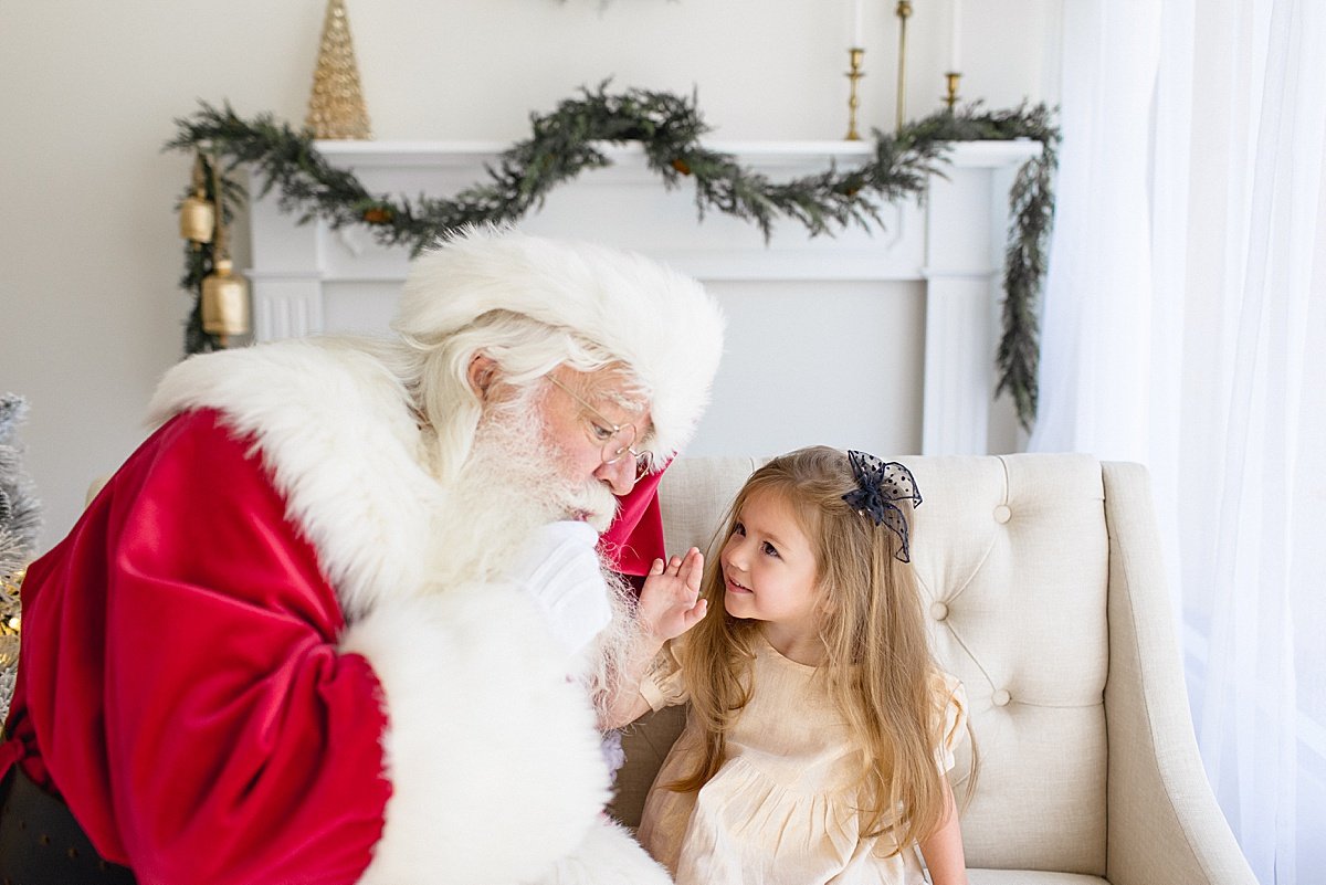 Santa talking to young girl during Santa's Magical Experience with Ambre Williams Photography in Newport Beach studio | Holiday Winter Session