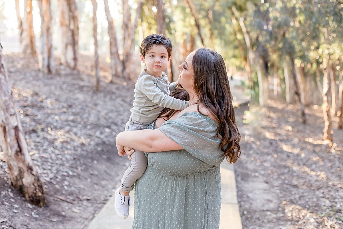 Mom and Son playing together during fall family portrait session with Ambre Williams Photography in Newport Beach Lake Forest California