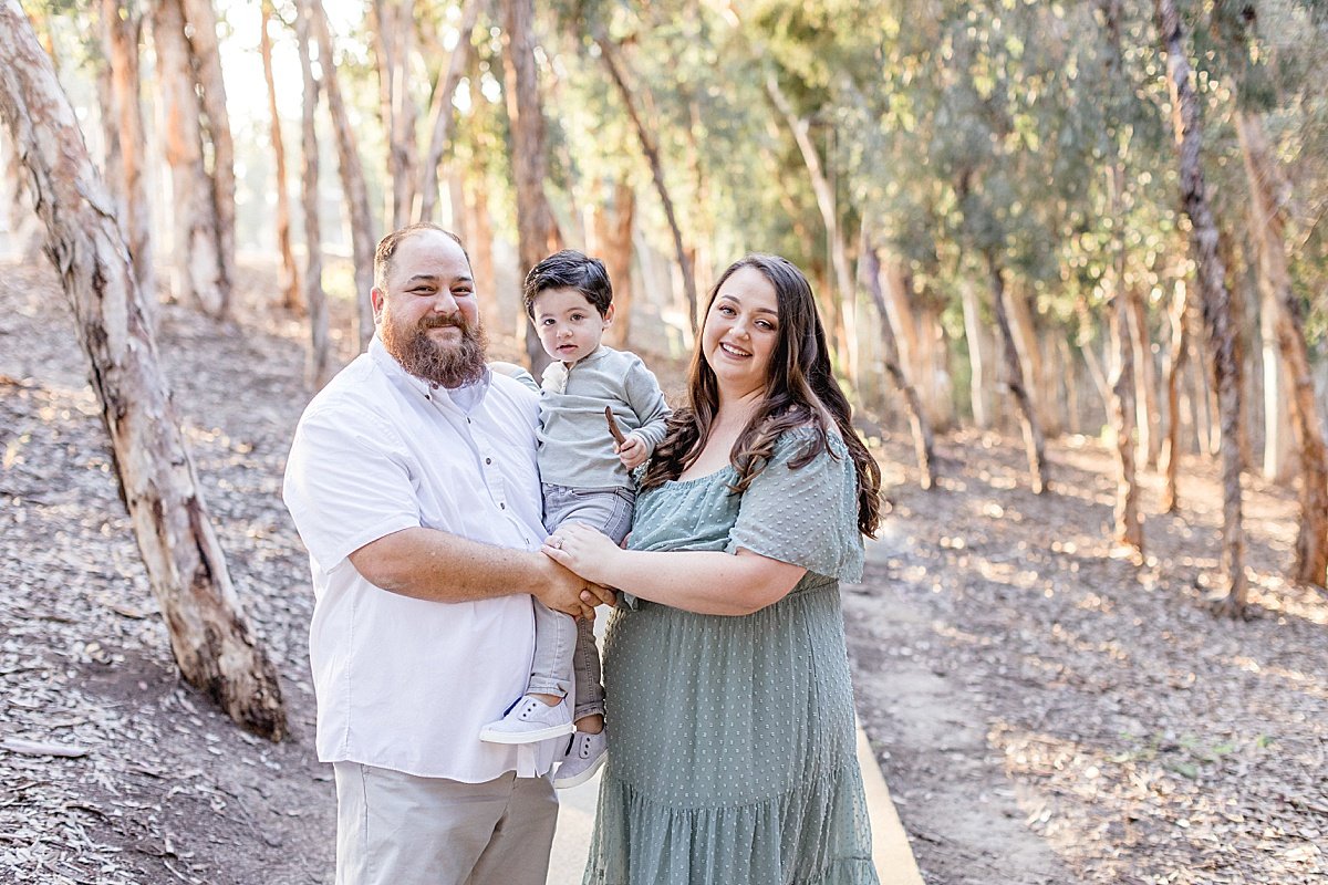 Family portrait of mom, dad, and son during outdoor portrait session in Lake Forest with Ambre Williams Photography