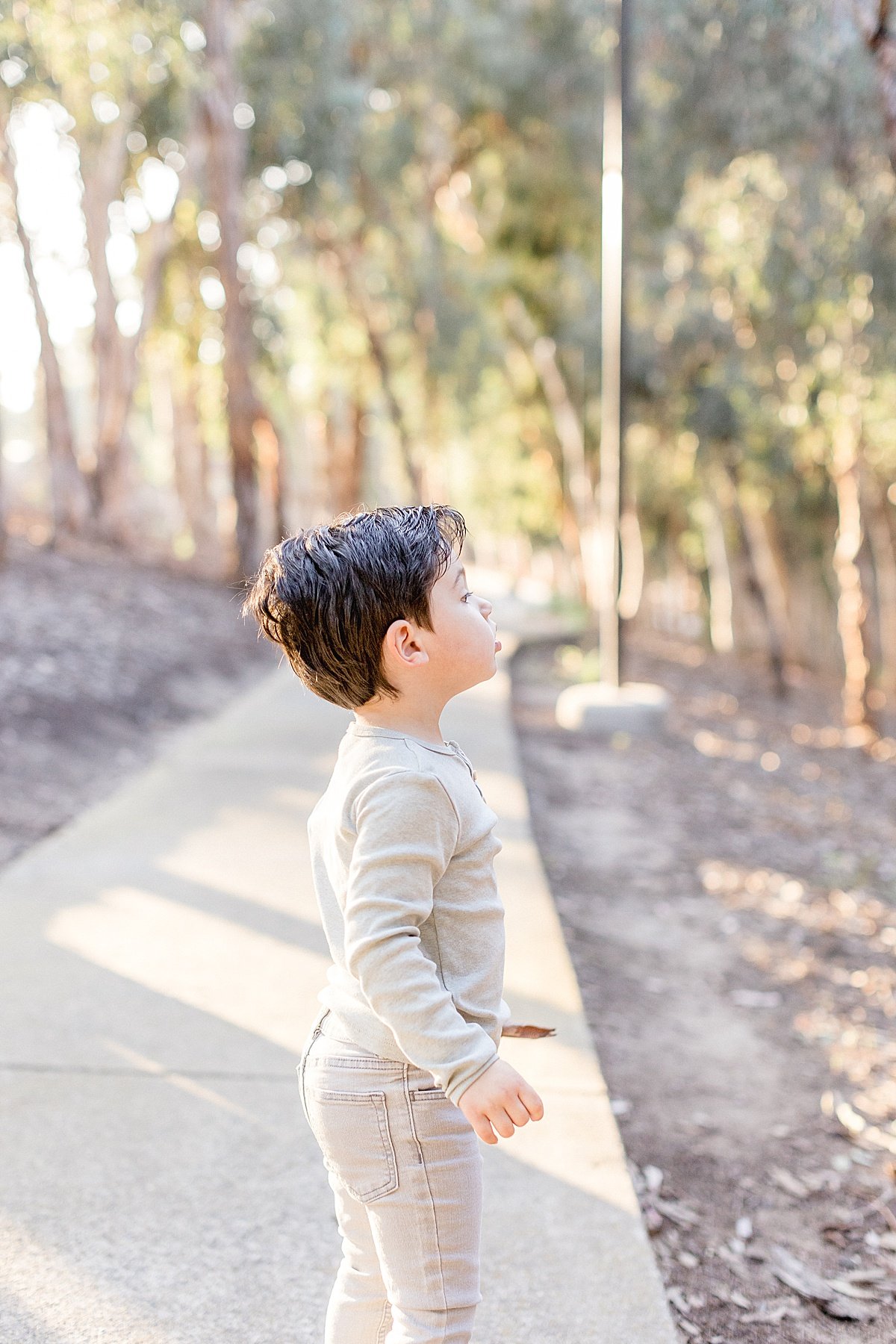 Son looking up candid portrait with mom and dad with Ambre Williams Photography