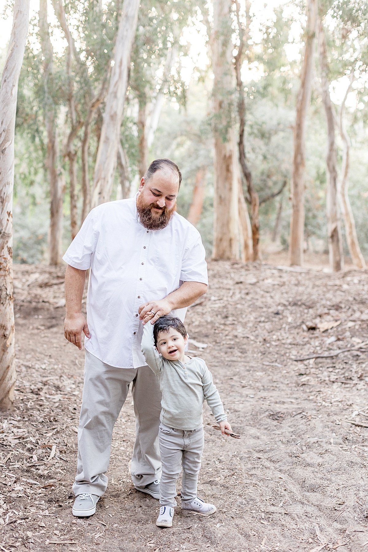 Dad and son walking together in the forest with Ambre Williams Photography | Family outdoor fall session in Lake Forest, CA
