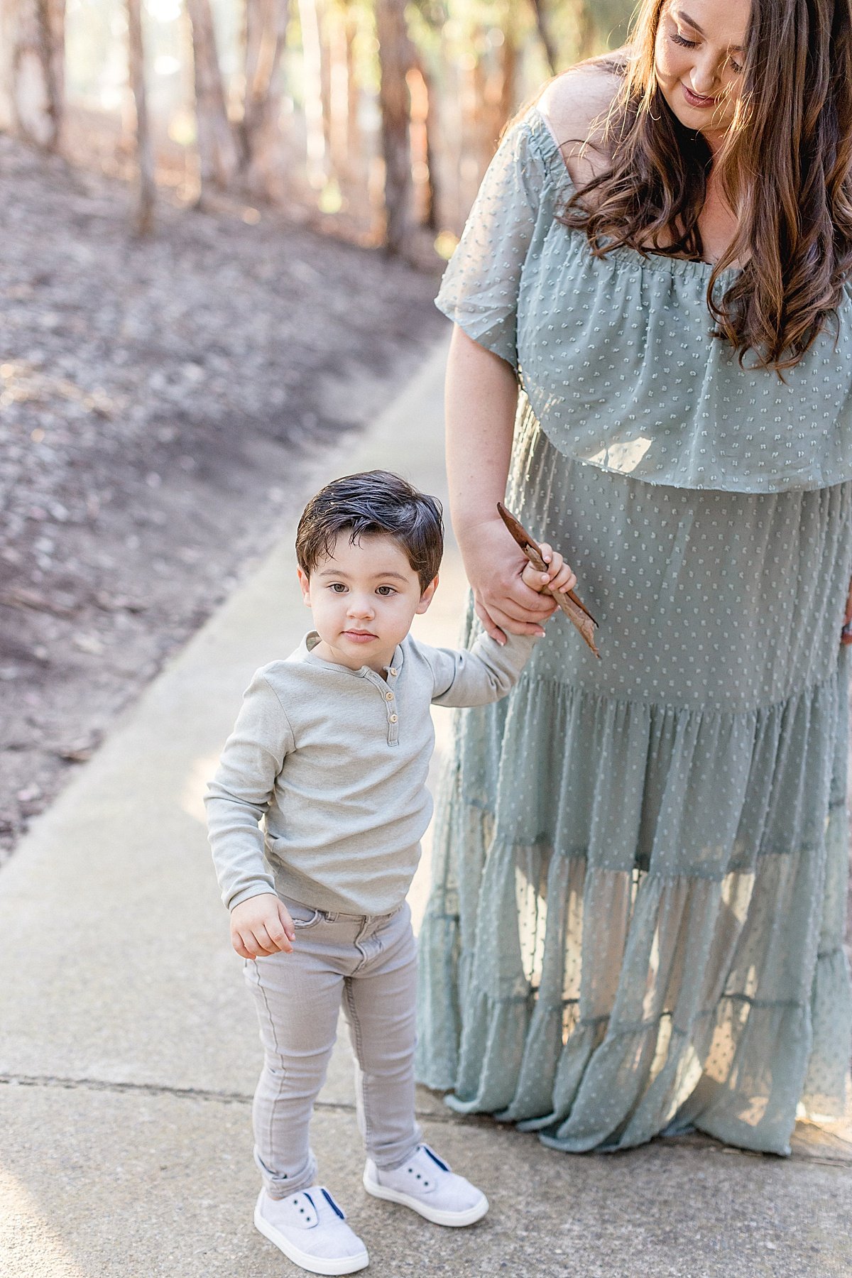 Son and Mother candid portrait looking past camera during fall session with Ambre Williams Photography