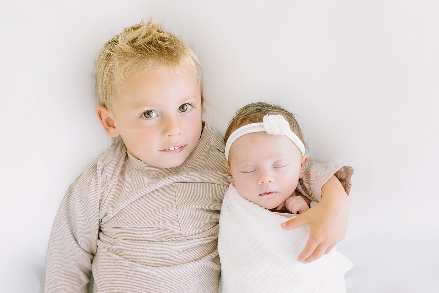 Newborn with big brother in studio with Ambre Williams Photography