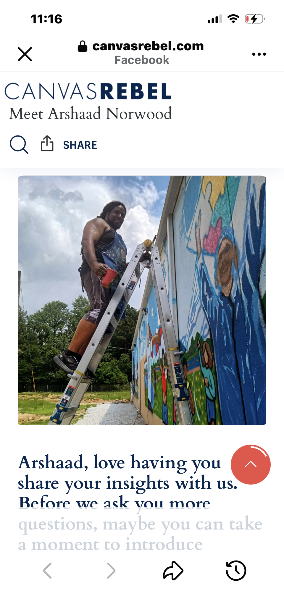 A man standing on a ladder painting a colorful mural on a building's exterior wall.