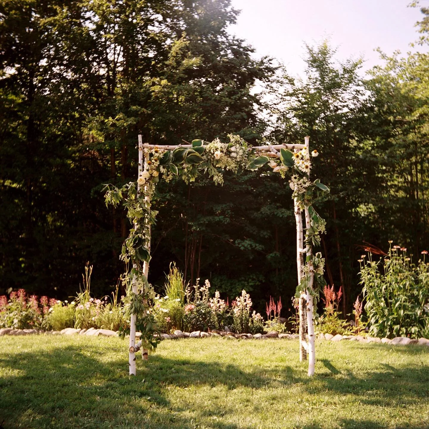 Pat &amp; Lily&rsquo;s wedding arch in Vermont, festooned with flowers from the garden. 🌸🌼🪻

Bonnie Burke Weddings || Austin Wedding Photographer || Notch House wedding || Vermont Wedding Photographer || Vermont Wedding