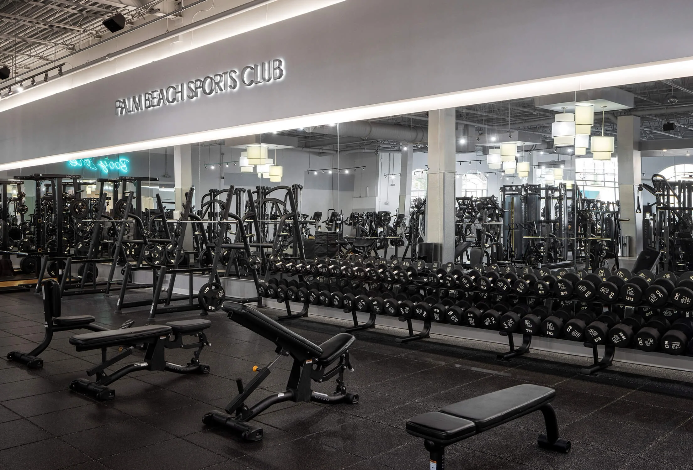 Gym weight area with mirrored walls emphasizing strength and wellness, by Commercial Architecture Photographer NYC.