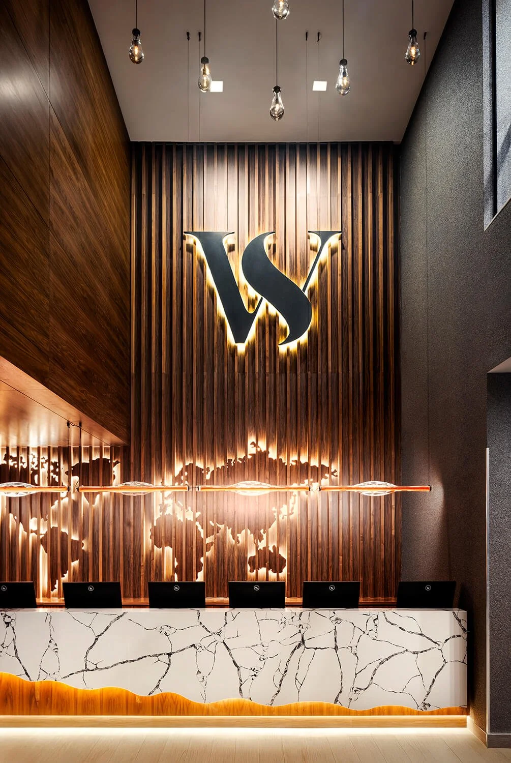 Spa-inspired fitness reception area with modern lighting, photographed by Architectural Photographer Long Island