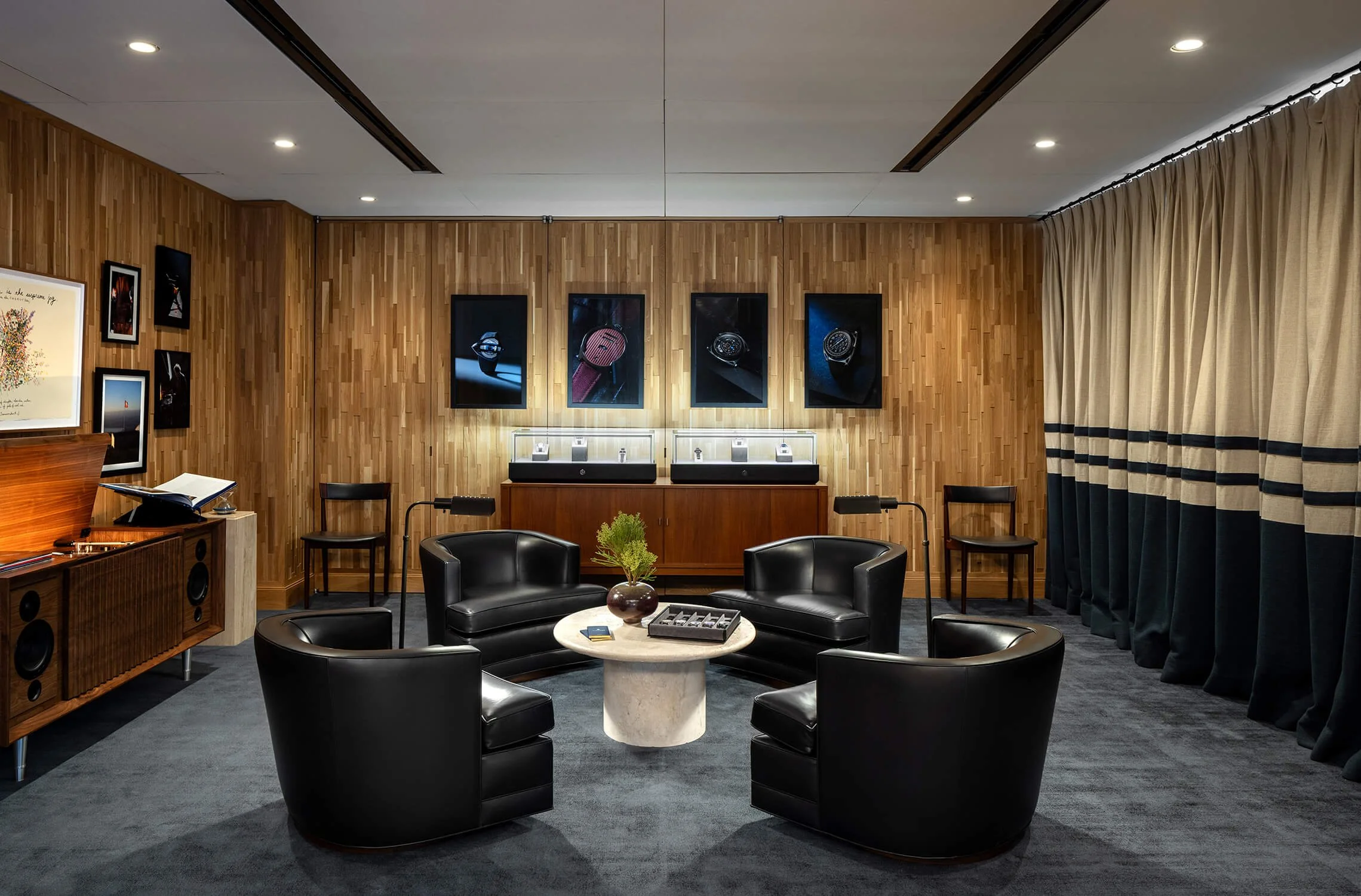 Luxury listening room with black leather chairs, art covered walls and warm wood paneling, 1916 Company Madison Avenue, Brian Berkowitz Photography
