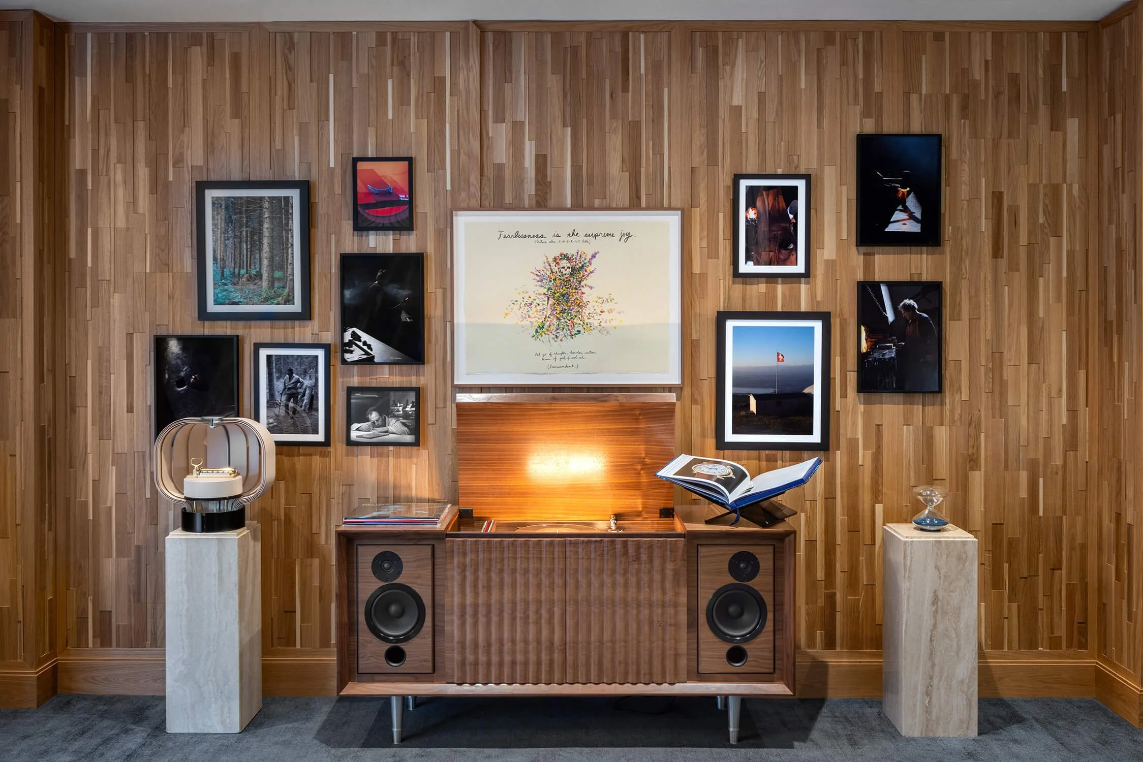 High-end listening room with art gallery wall, vintage speaker on marble plinth and wood paneling, 1916 Company NYC, Brian Berkowitz Photography
