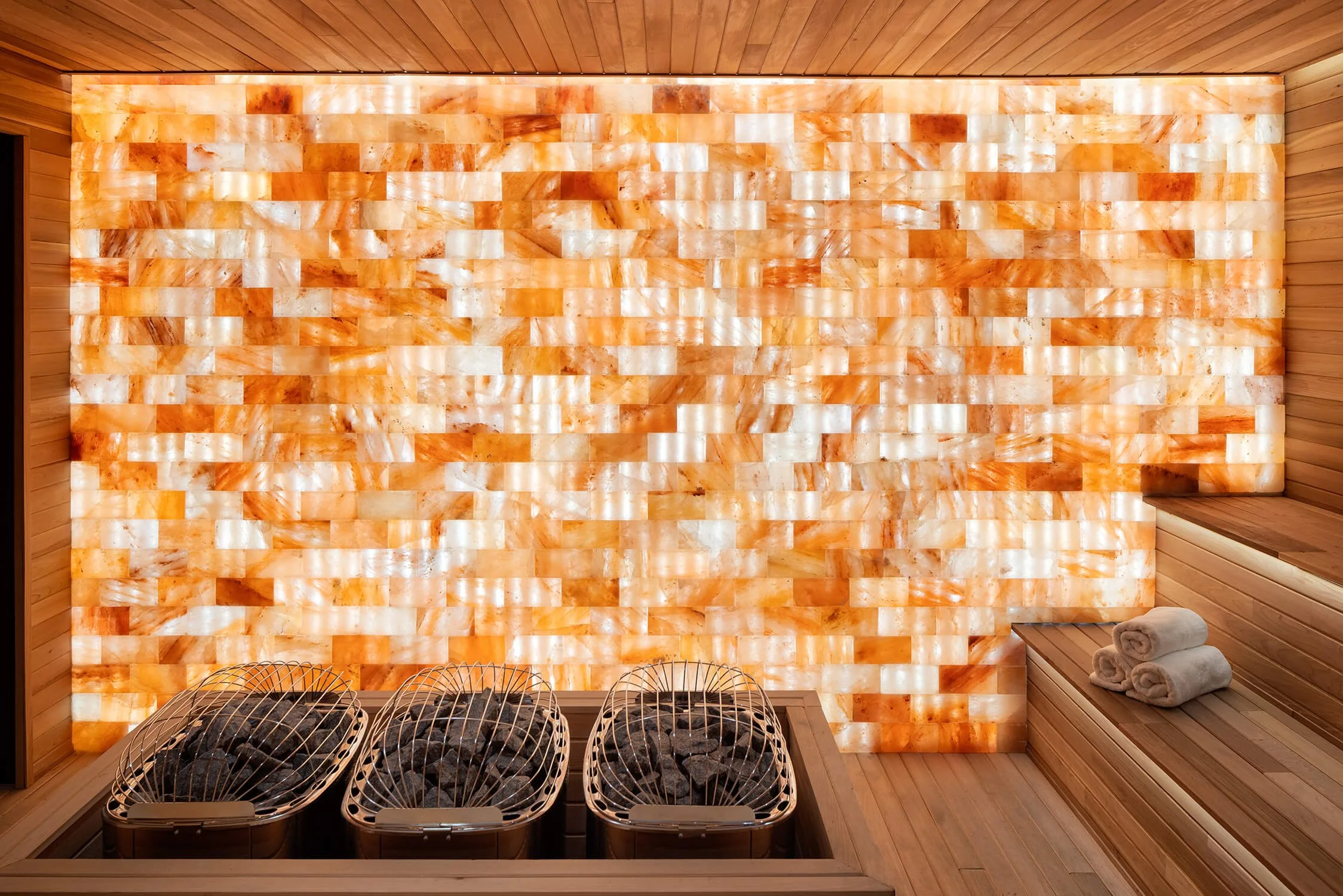 Himalayan salt wall inside sauna glowing with ambient backlight