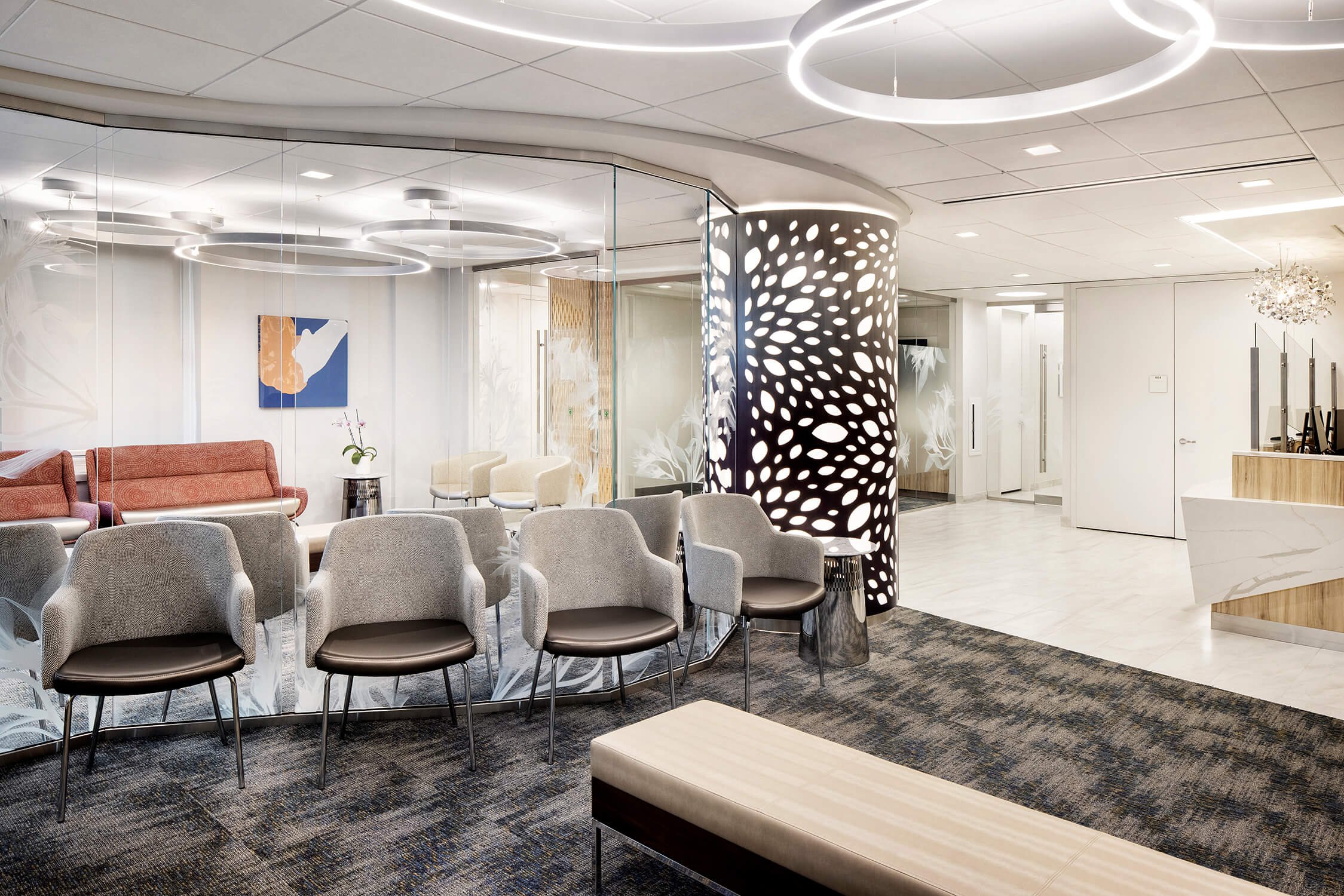 Weill Cornell Medicine fertility center reception with perforated screen wall and chandelier, healthcare photography by Brian Berkowitz Photography NYC
