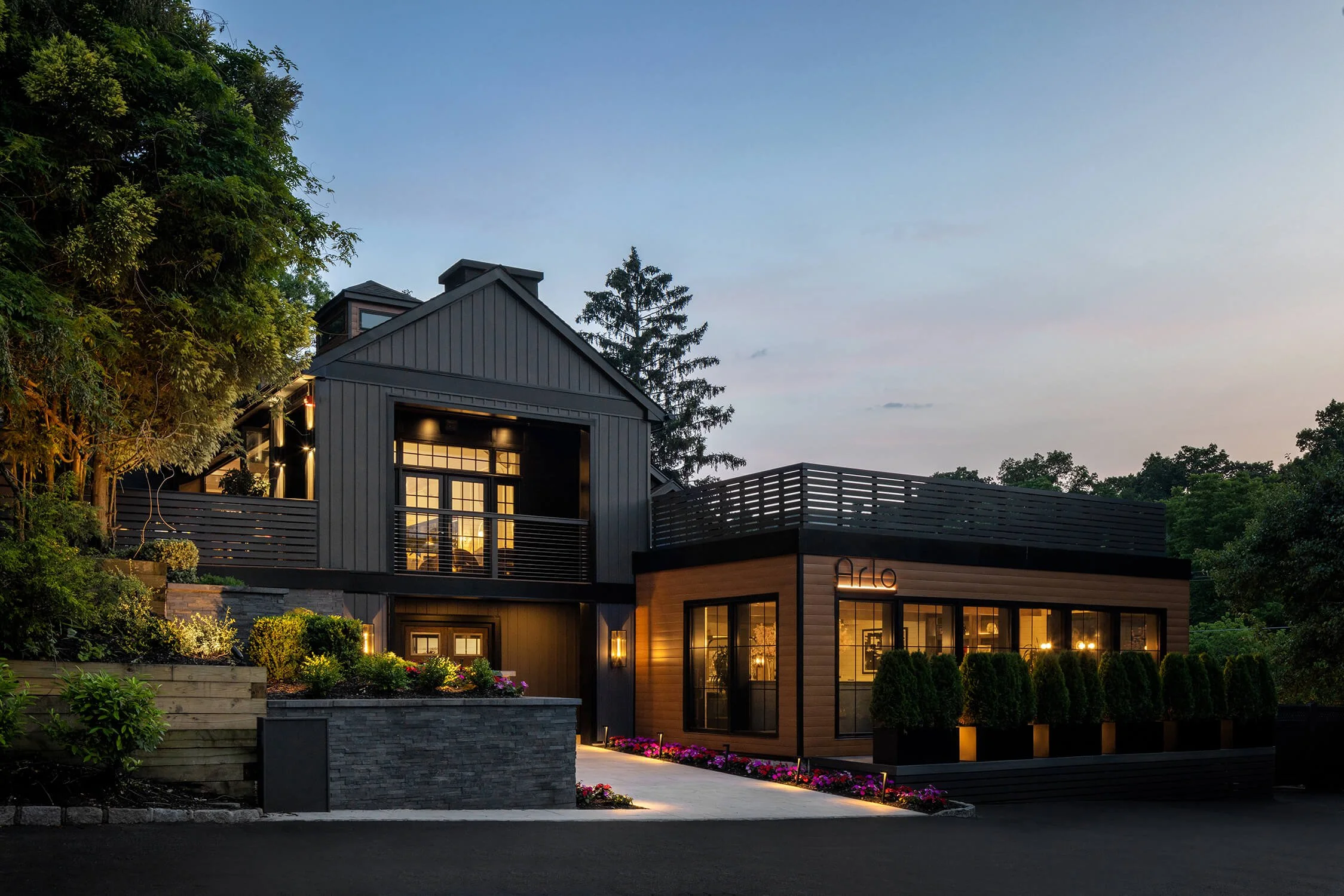 Arlo restaurant exterior at dusk with modern farmhouse architecture and warm lighting, hospitality photography by Brian Berkowitz Photography