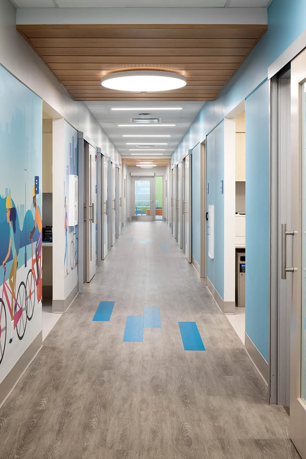 Cohen Children's Northwell Health corridor with full length mural art and blue floor markers, healthcare photography by Brian Berkowitz Photography New York