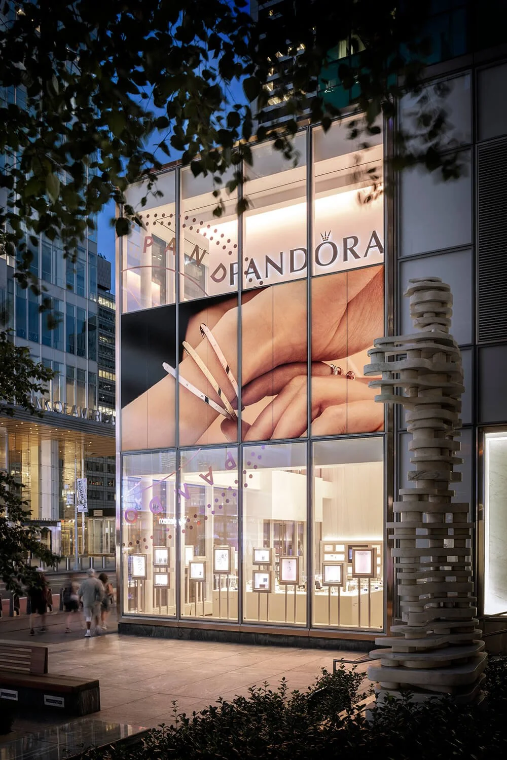 Pandora retail store in Times Square at night featuring a sculpture from the park next door