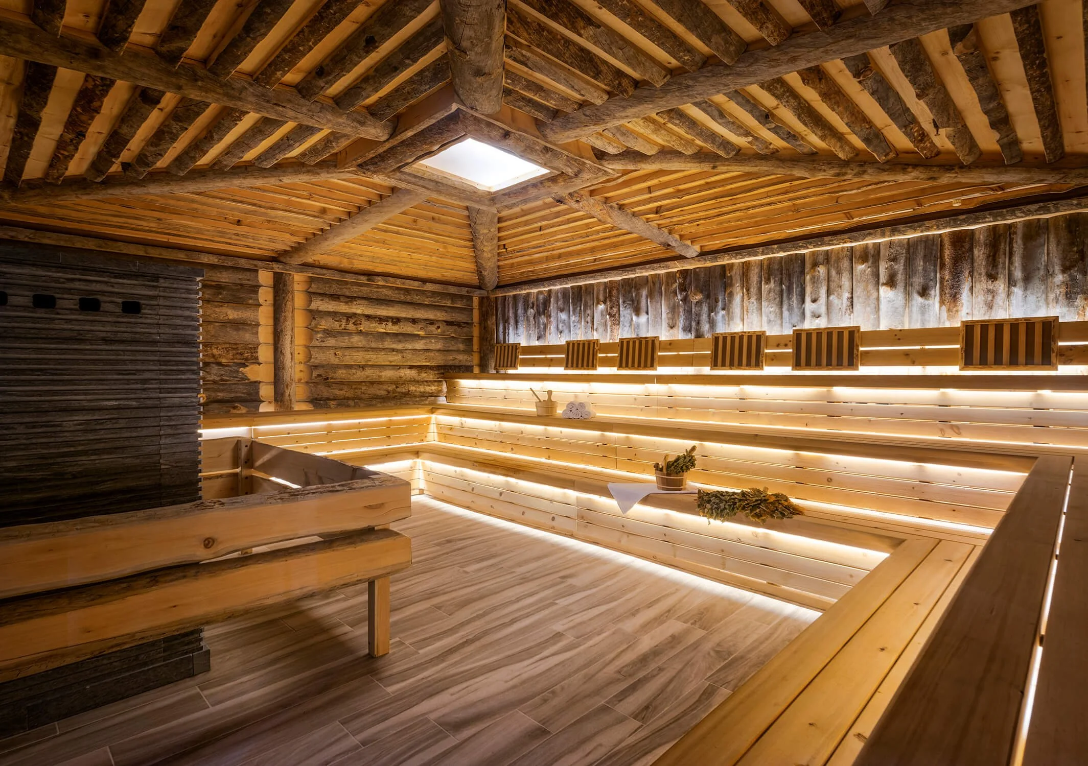 Large log sauna with warm ambient lighting, photographed by Interior Design Photographer NYC.