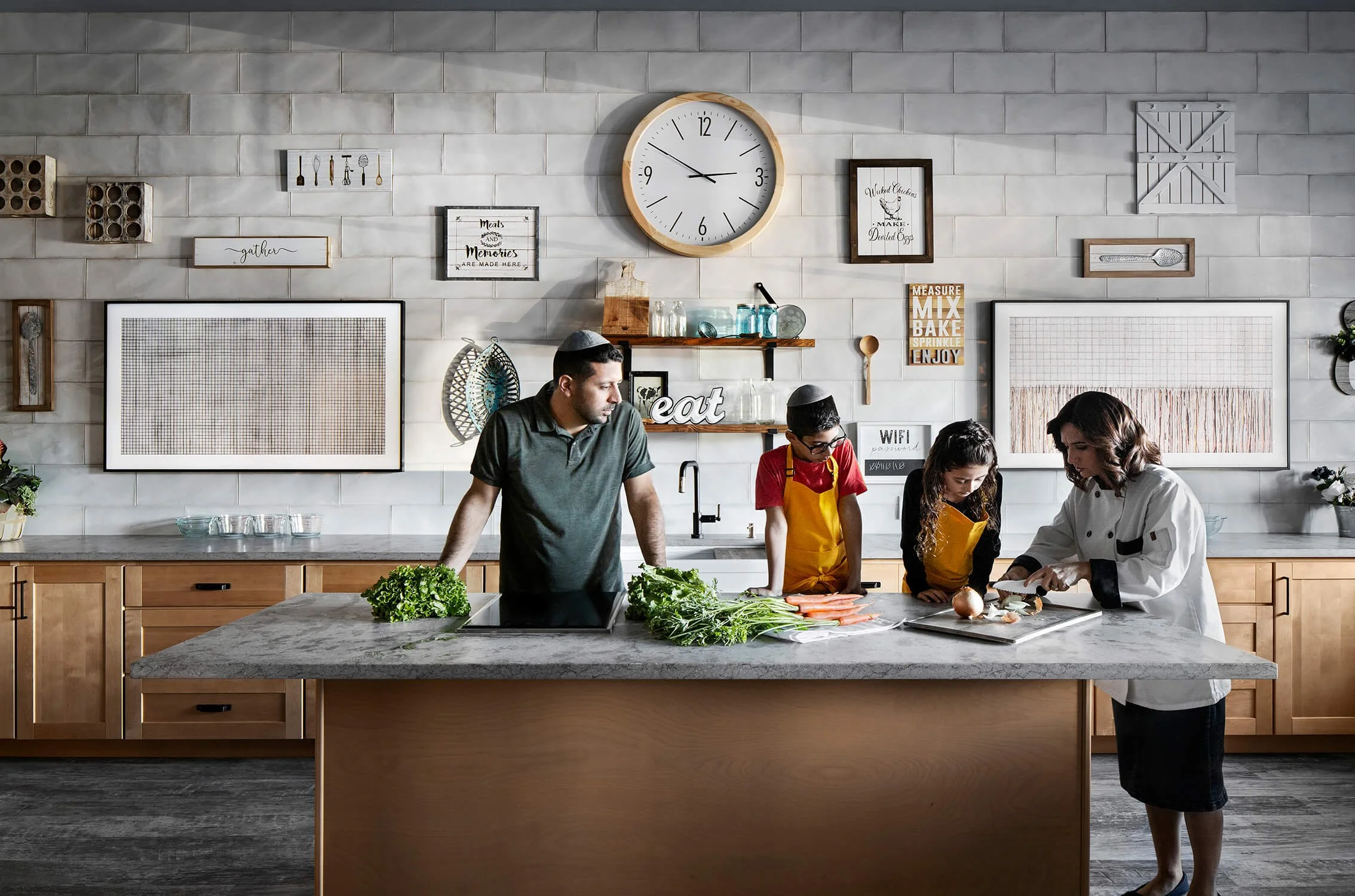Culinary classroom with family and chef cooking at island, commercial interior photography by Brian Berkowitz Photography