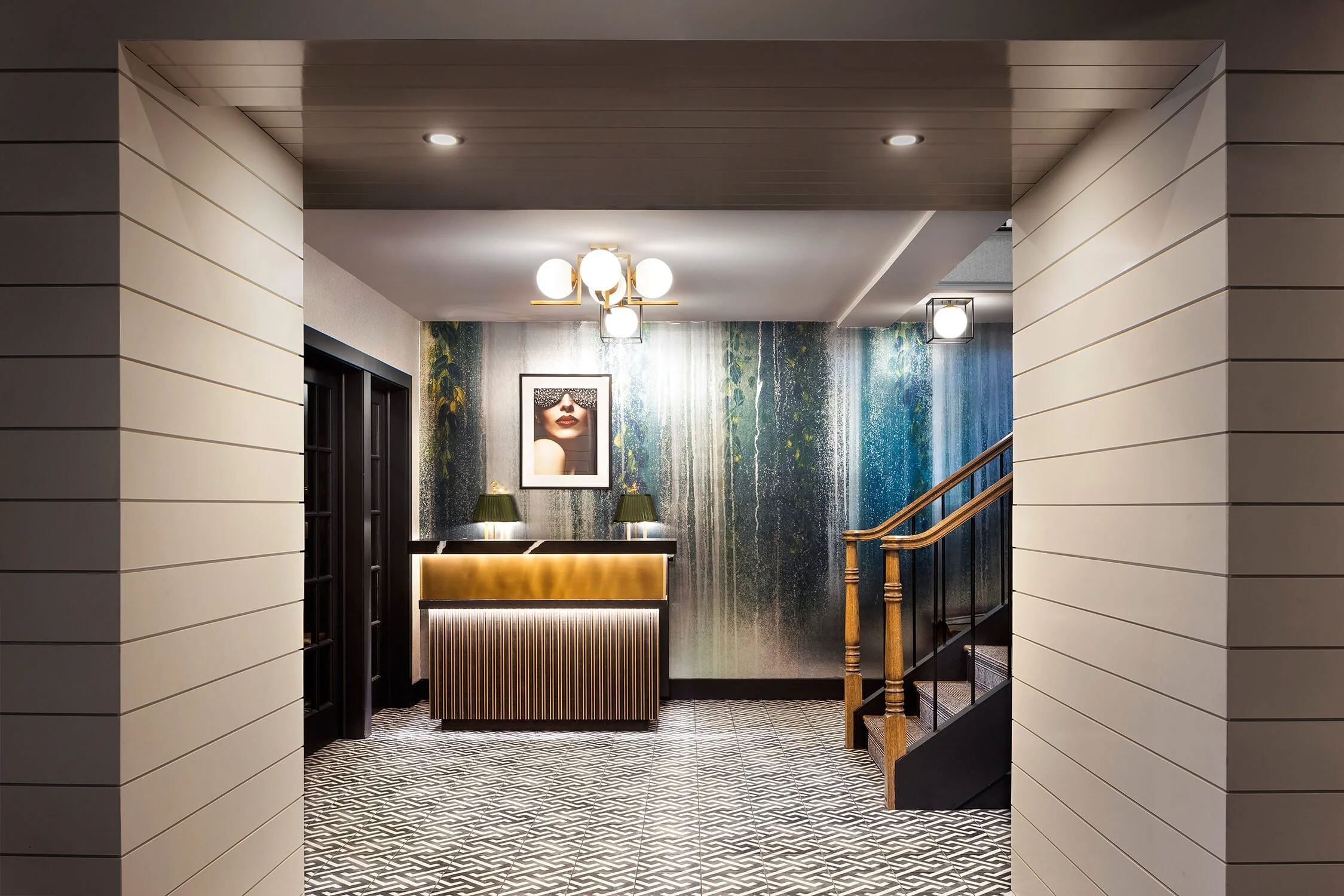 uxury restaurant lobby with brass reception desk and artistic wallpaper mural, hospitality photography New York