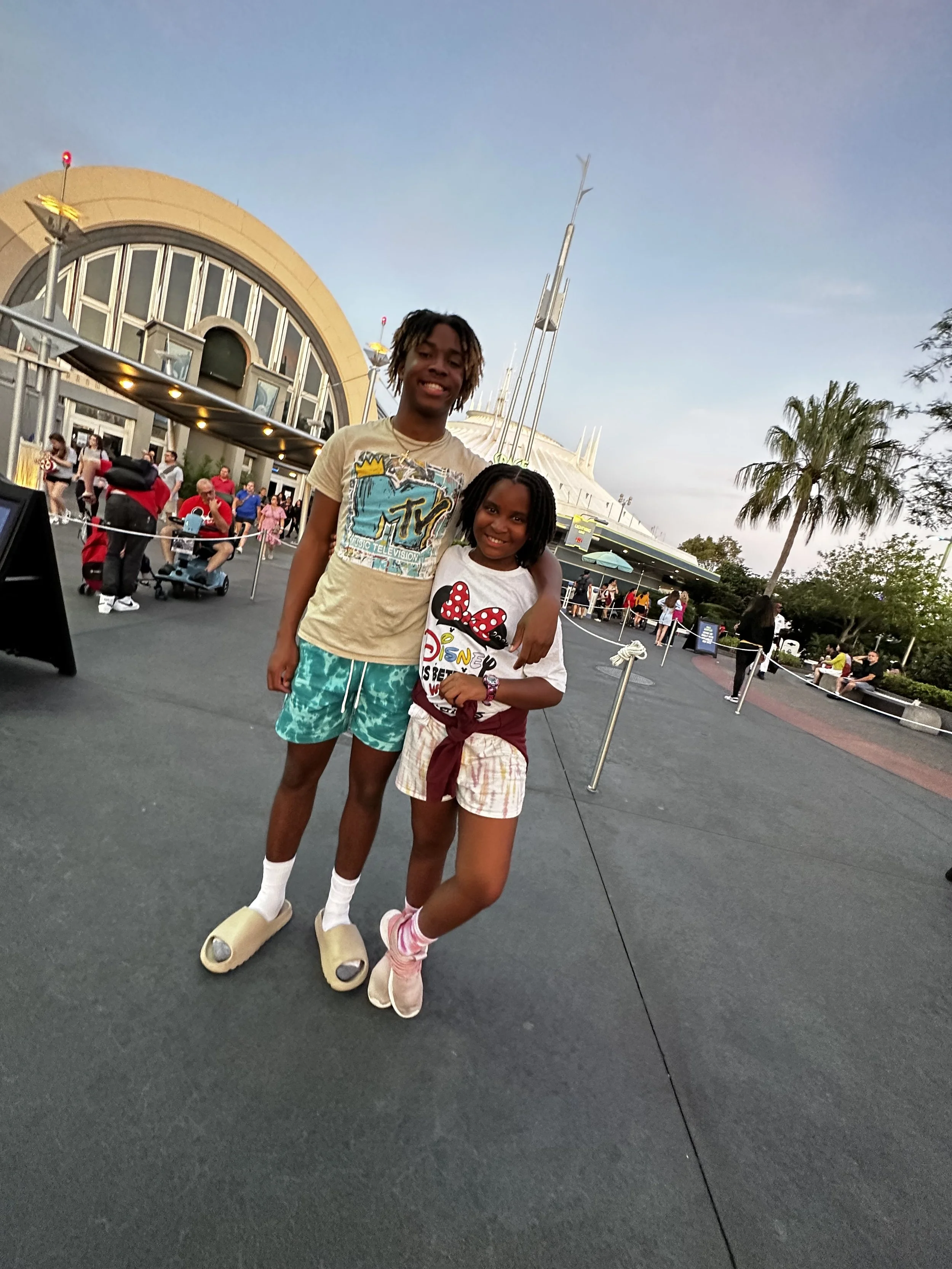 E at Disney World with his sister.
