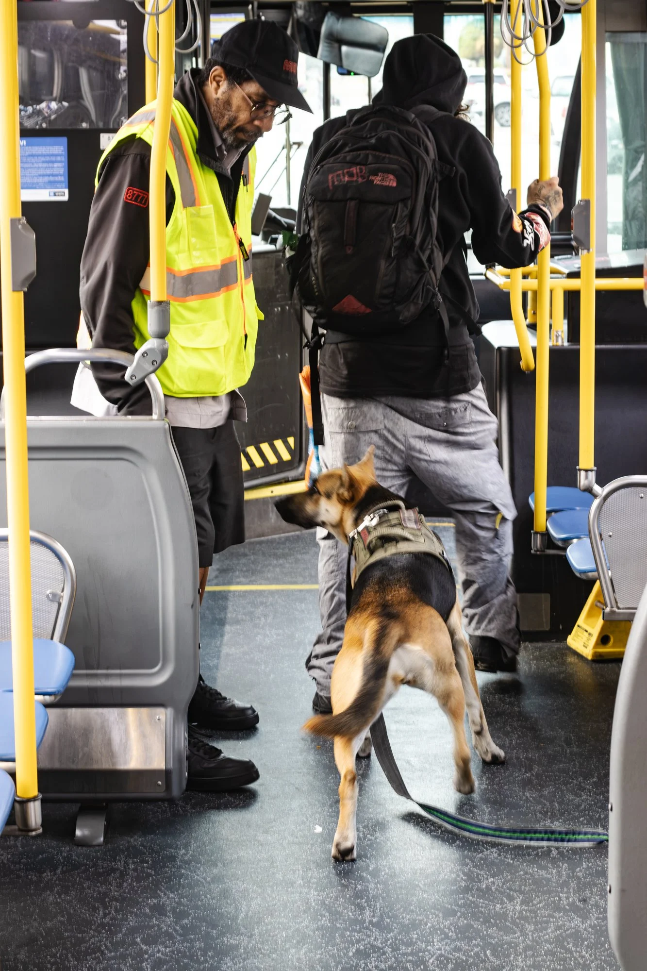 Bryan escorts unhoused man and dog out of the bus. From 'Doors Are Opening' project, in progress. October 2026. 