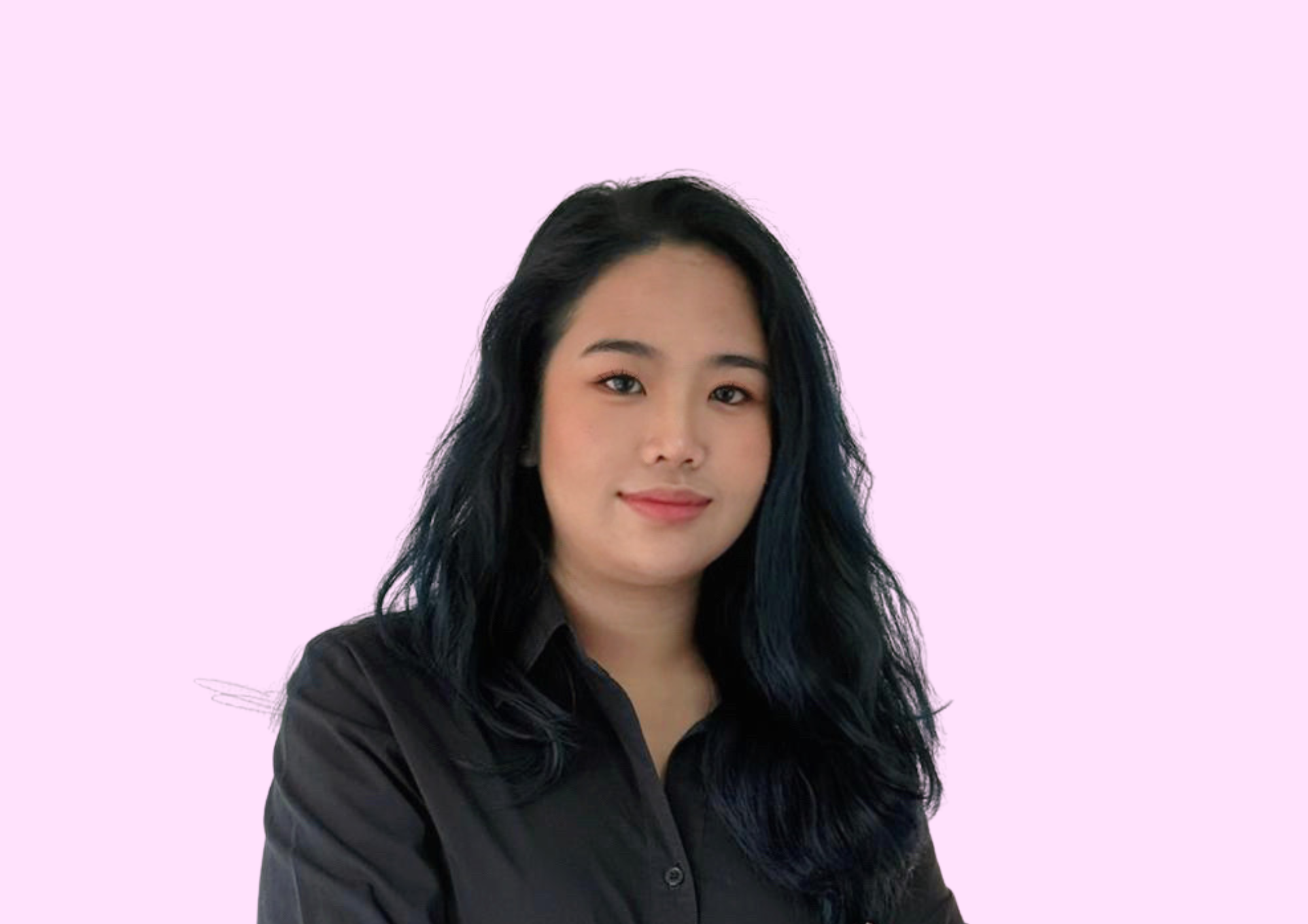 Portrait of a young woman with black hair wearing a black shirt, set against a light lavender background.