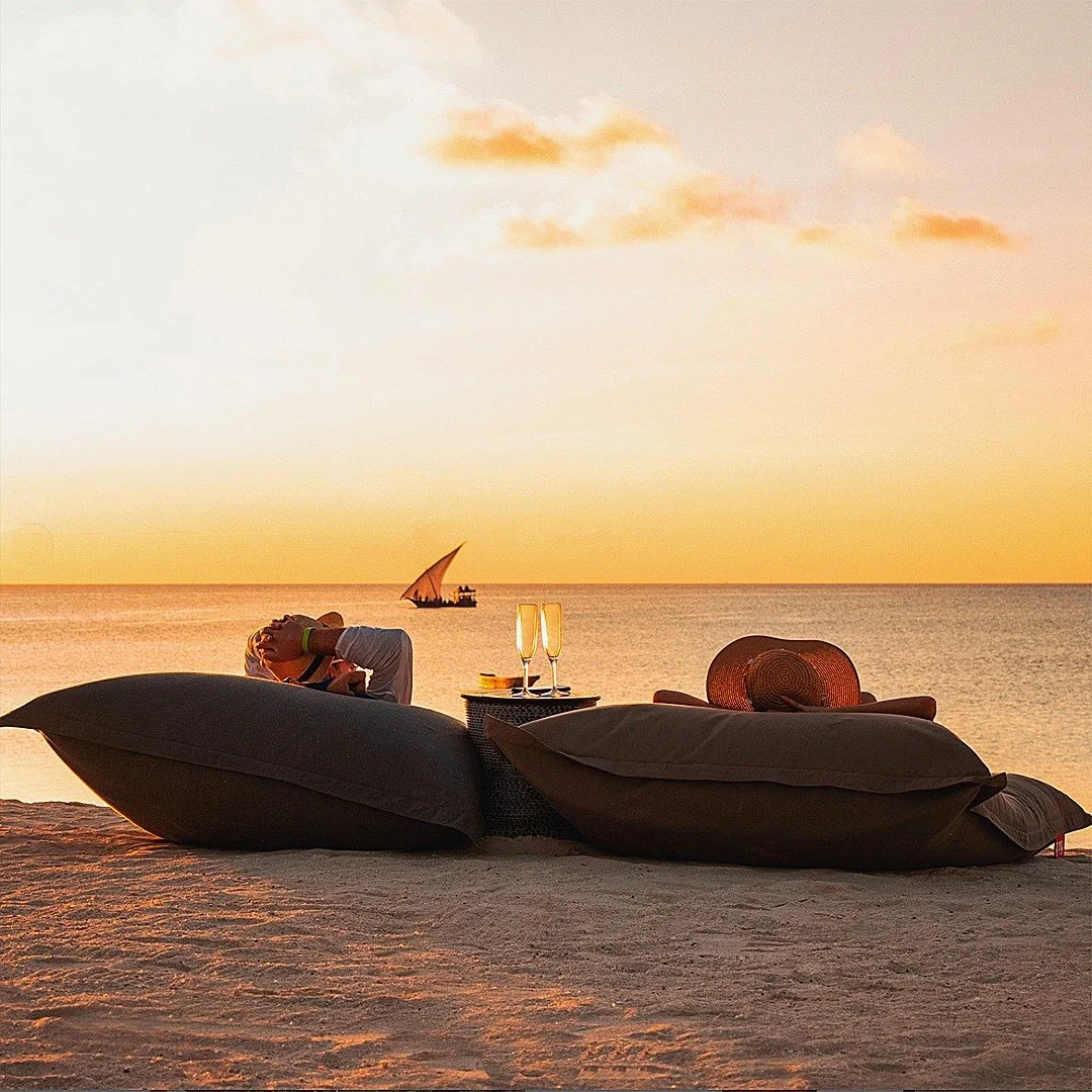 As daylight turns into dusk, it is time for a longstanding safari tradition: the sundowner. 

Whether you are deep in the bush or relaxing on the beach, there is nothing quite like sipping a cold drink as the sun melts into the horizon.

Where would 