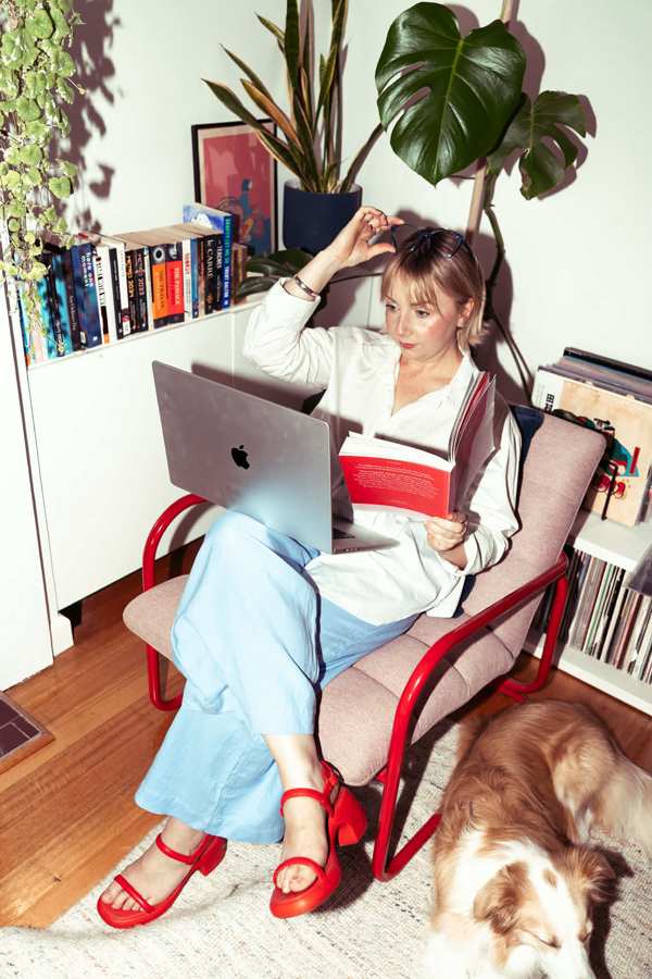 Creative Director and Founder of Bobby Mac, Hayley, sitting on chair with laptop in design studio in Melbourne, Australia