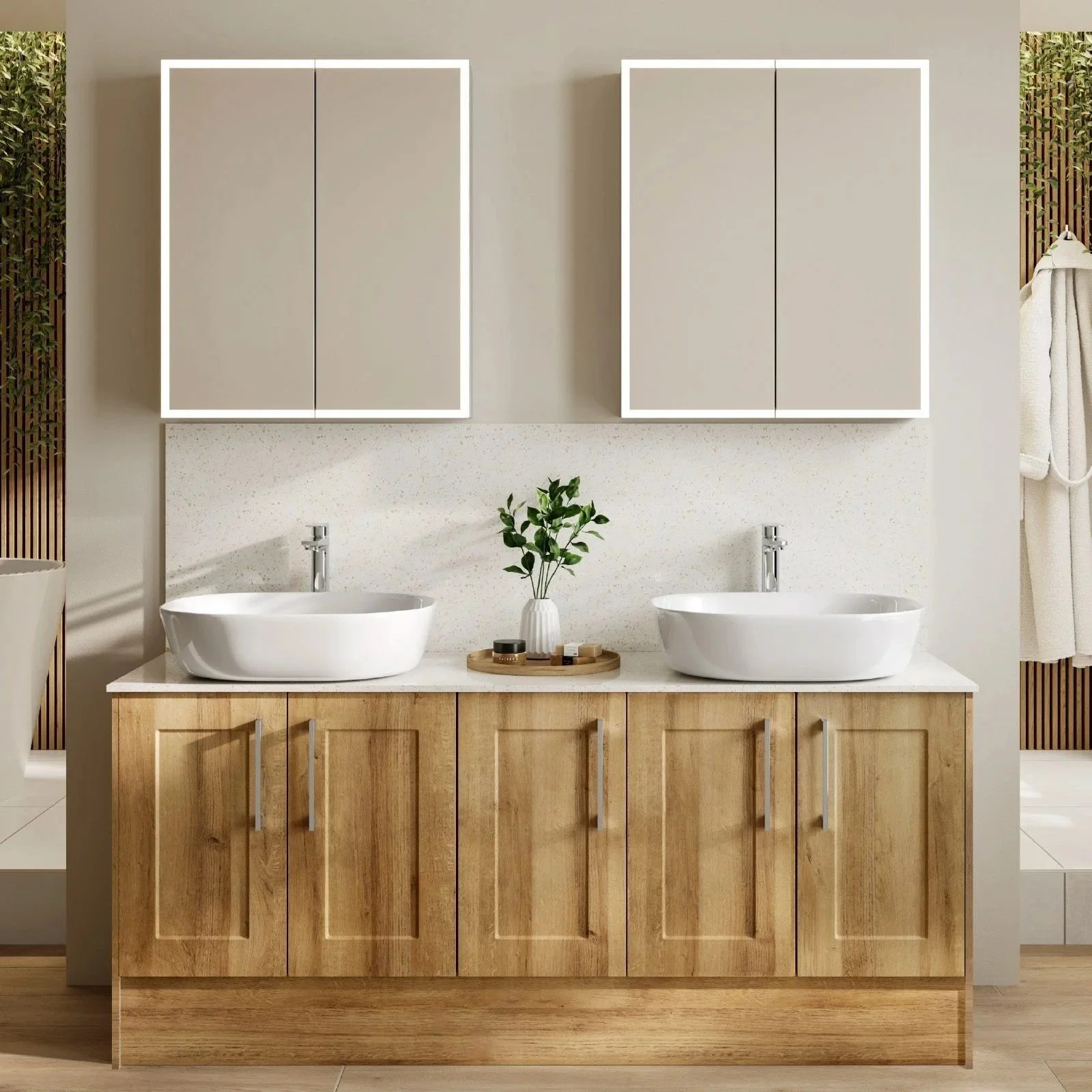 Modern bathroom with double sinks on a wooden vanity, two white cabinets with black accents above, a small potted plant in the center, and a beige wall with wood accents.