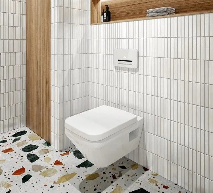 Modern bathroom with white tiled walls, terrazzo floor, and a wall-mounted toilet.