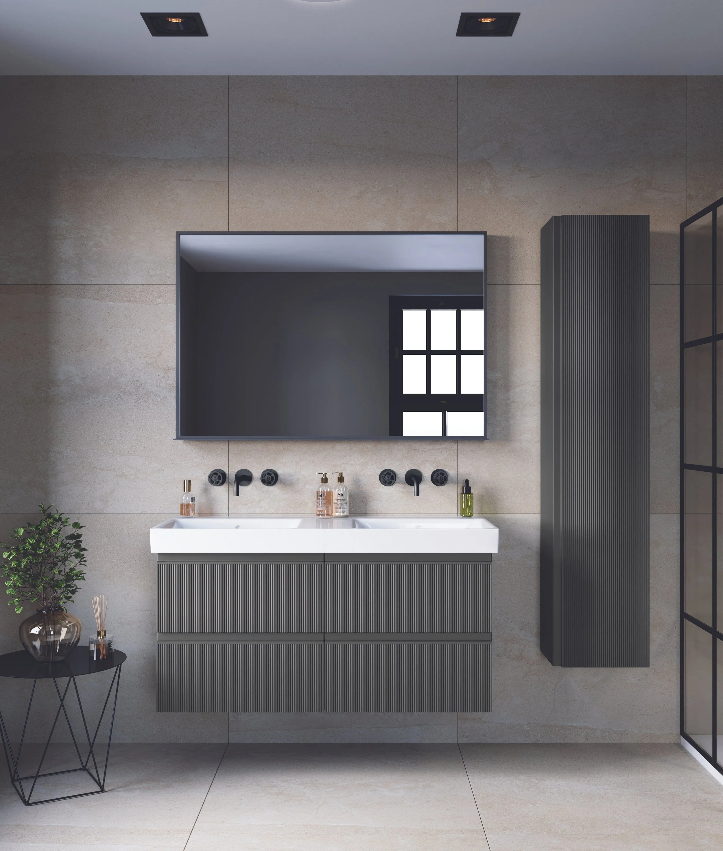 Modern bathroom with a white vanity sink, black framed mirror, black wall-mounted faucets, a black side table with a vase, and a tall black radiator. The wall is tiled with large beige tiles. See this bathroom display at Island Bathrooms Salisbury