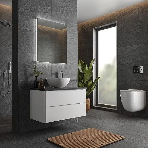 Modern bathroom with dark gray tiled walls and floors, stylish vanity units and bathroom furniture on display at Island Bathrooms Bournemouth