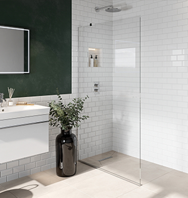 Modern bathroom with a walk-in shower, white subway tiles, a large mirror, a white vanity with a plant in a black vase, and beige floor tiles.