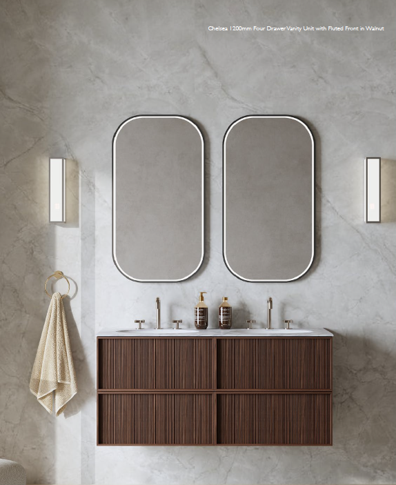 Modern bathroom with double vanity, two large oval mirrors, wall-mounted lighting, and a wooden cabinet with a textured finish. Dark wood effect bathroom vanity unit on display at Island Bathrooms Salisbury