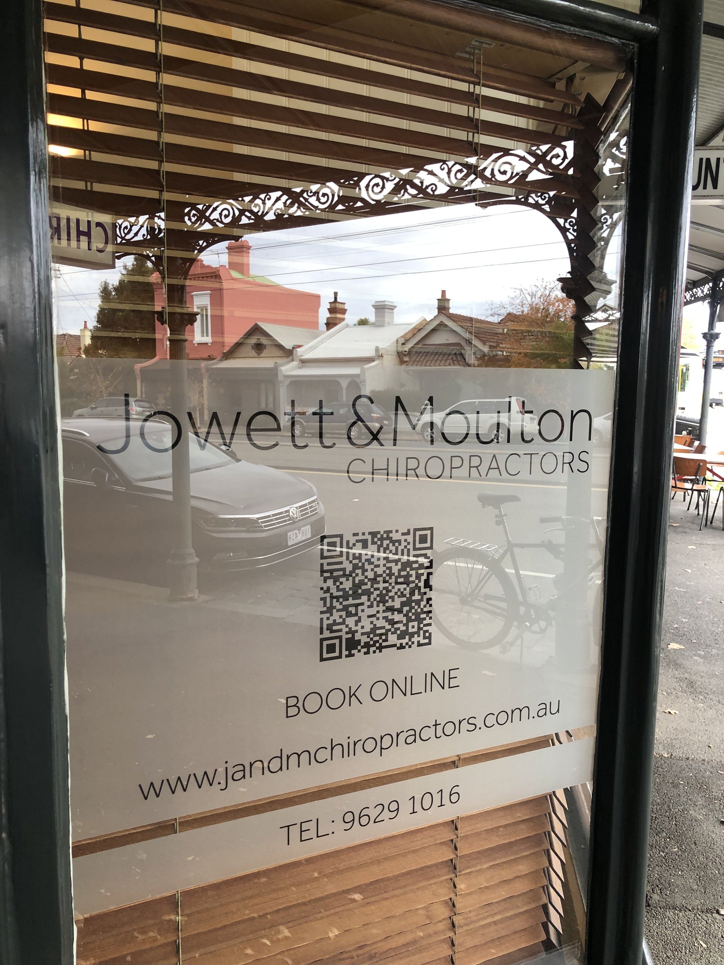 A sign on our new location that reads Jowett and Moulton Chiropractors Melbourne and has our phone number on it. 