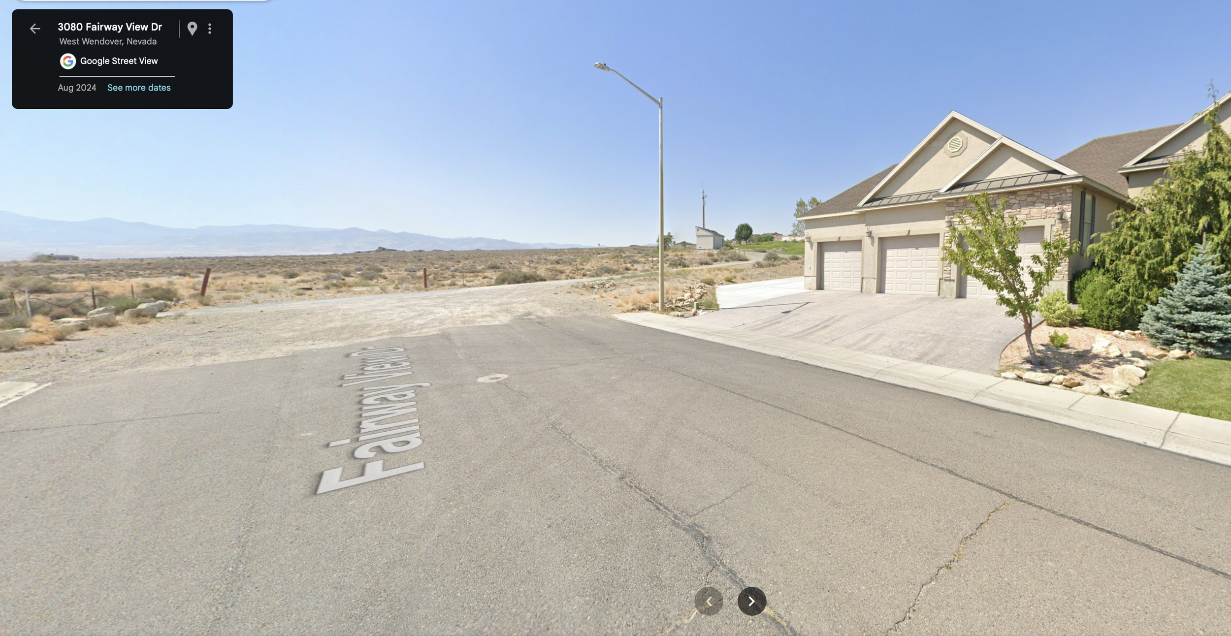 The image shows a residential street in West Wendover, Nevada, with a house on the right side that has a three-car garage and landscaping, including small trees and shrubs. The street is named Fairway View Drive, and the area is arid with a desert landscape and mountains in the background under a clear blue sky.
