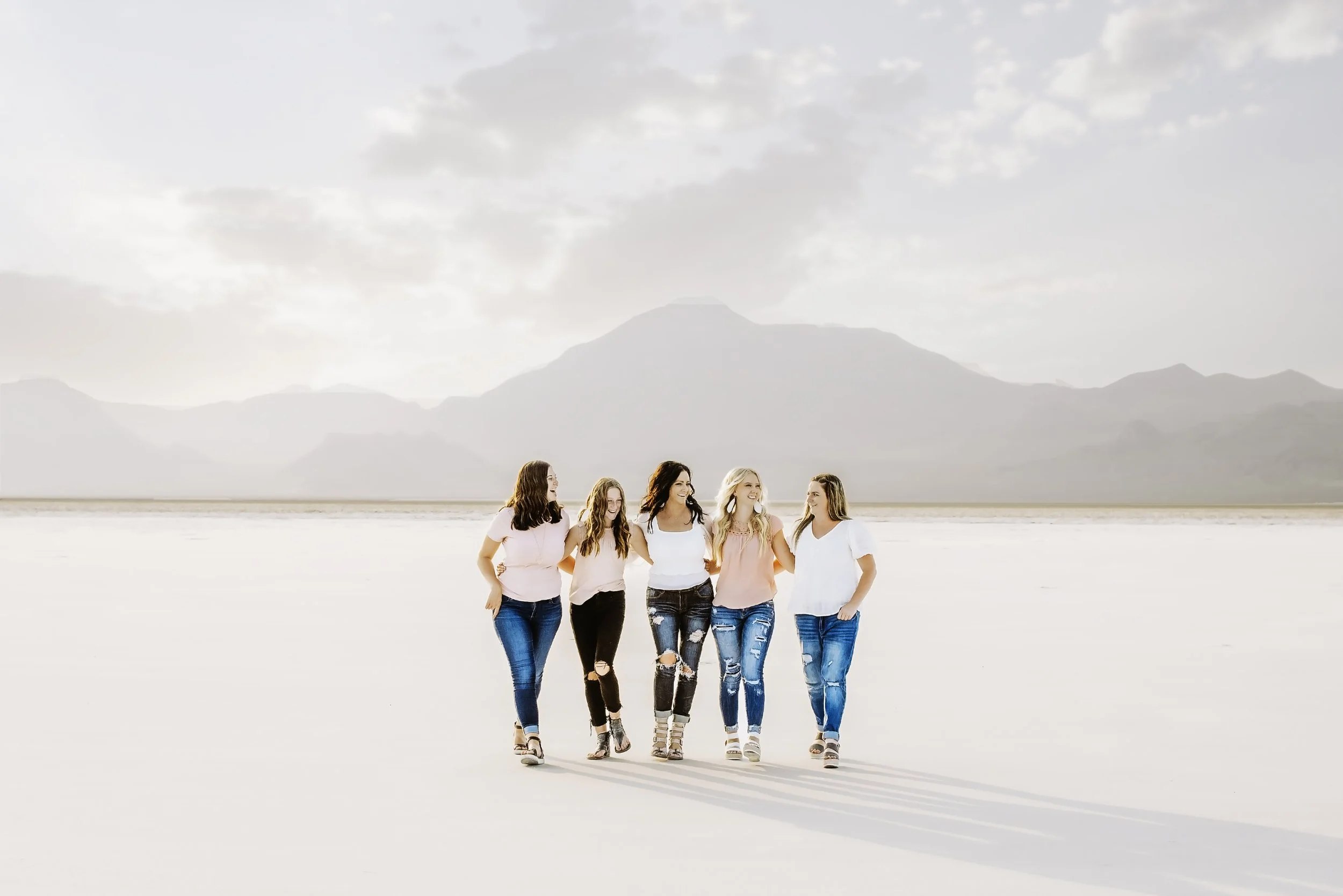 Women in pink walking across the Bonneville Salt Flats in Utah.