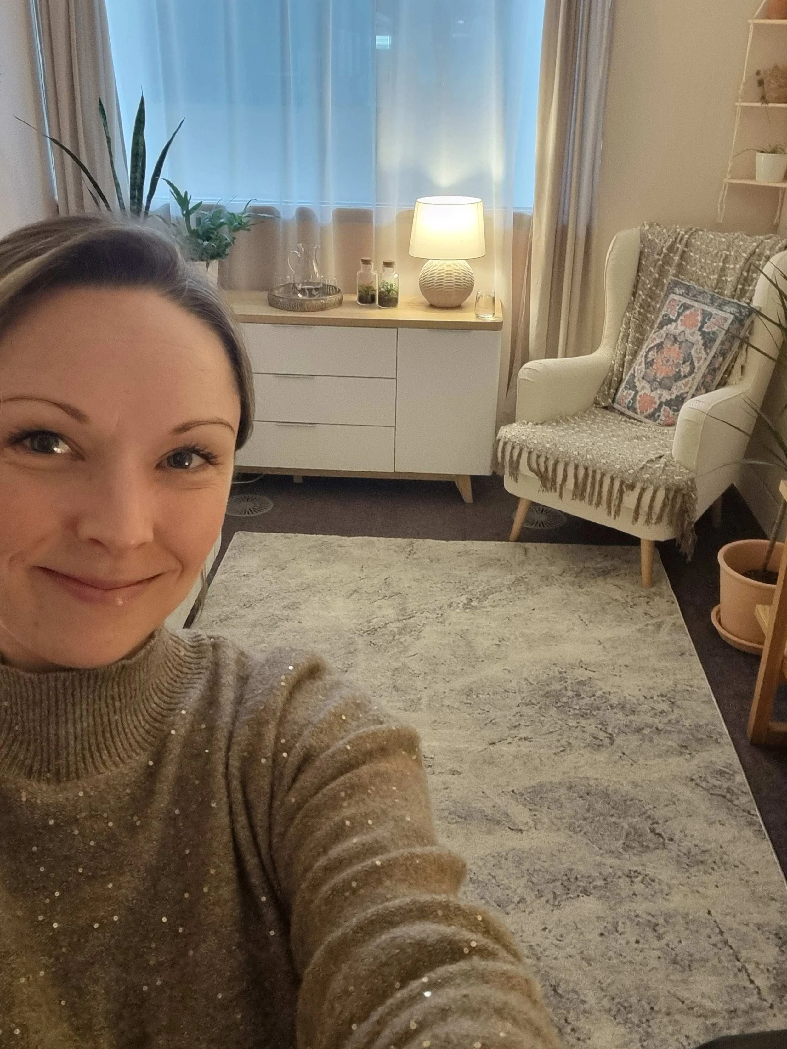 A selfie taken by Louise Burchell showing her finished counselling room behind her