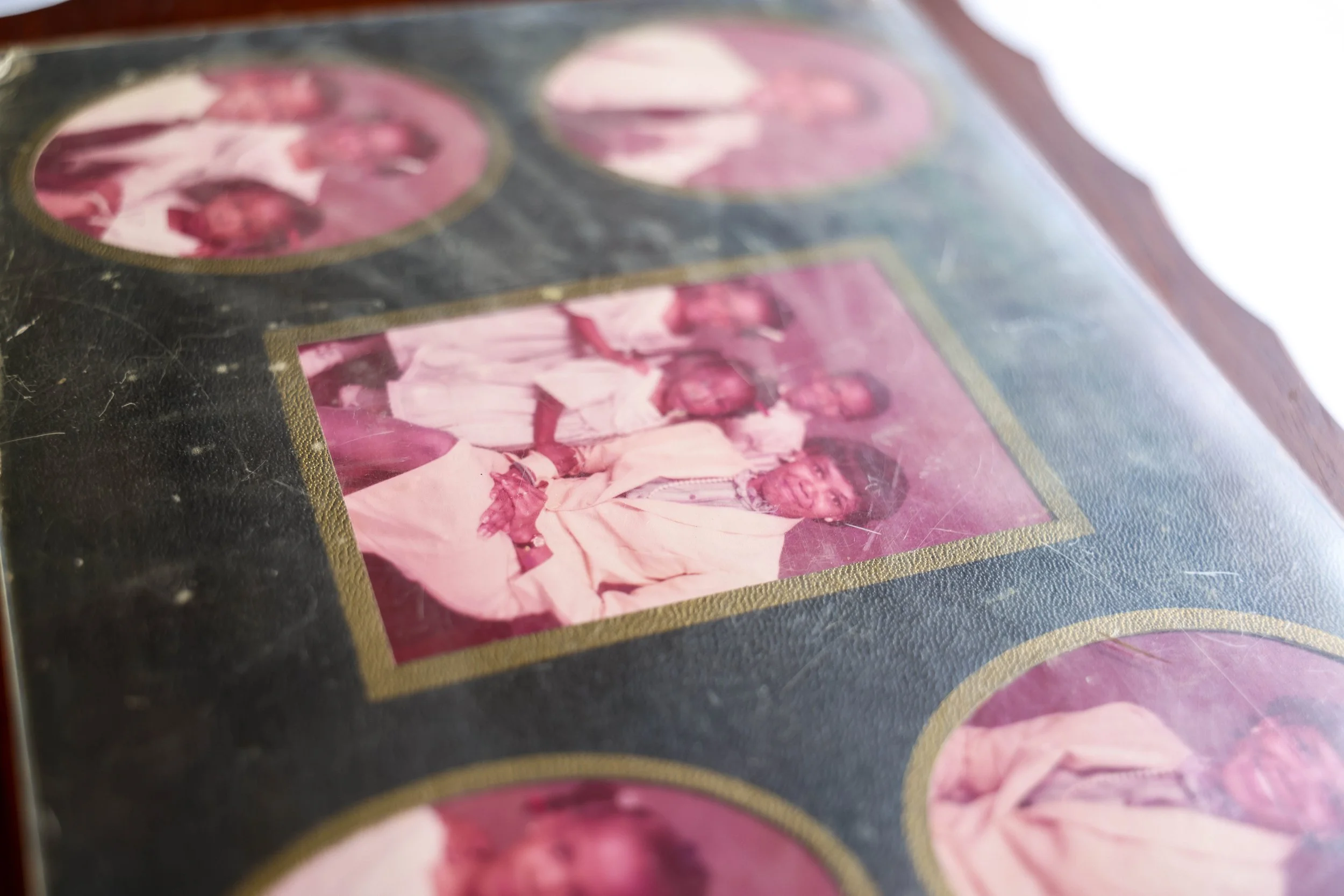 etail of framed family artwork from 1983 preserved across generations