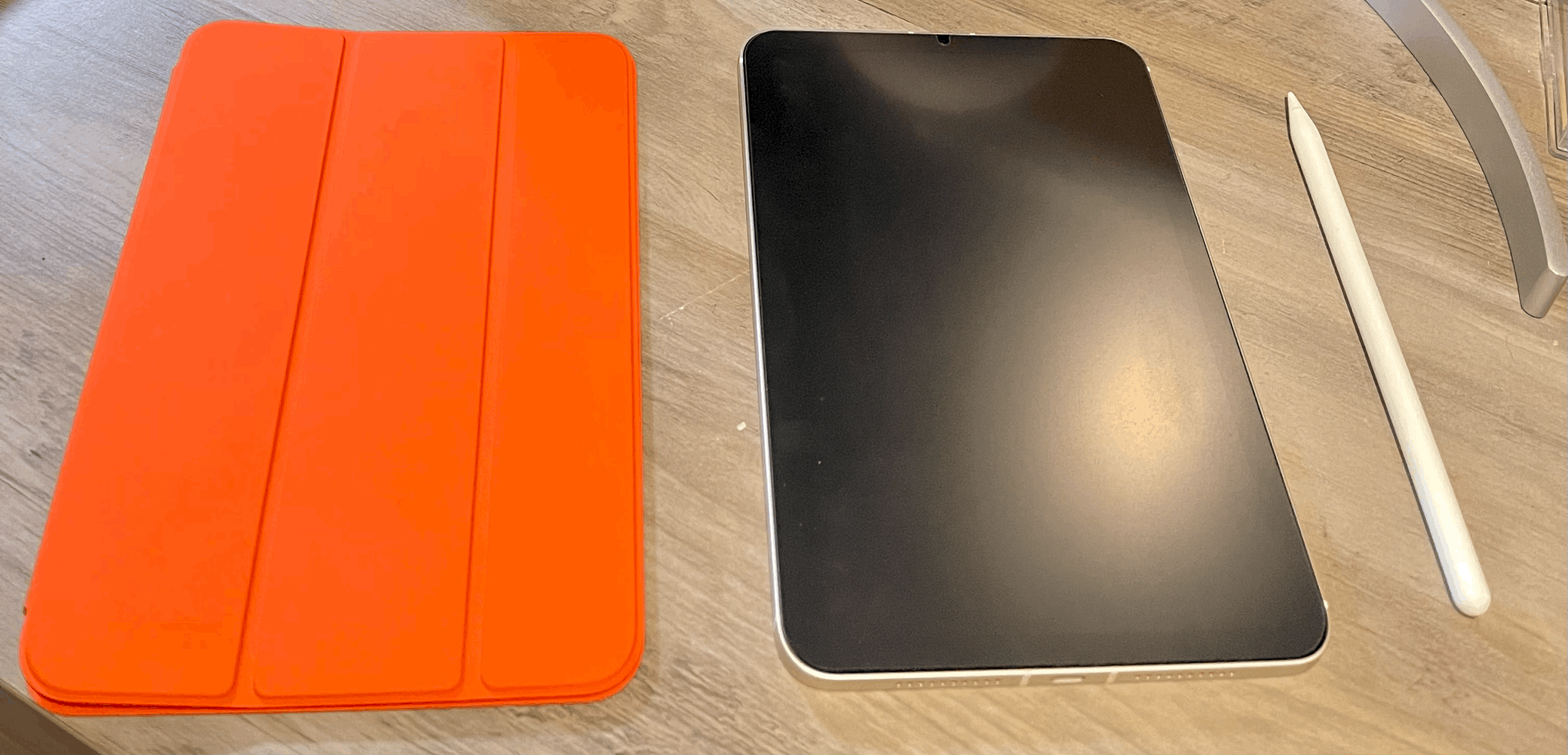 Apple iPad mini 6th Generation alongside orange case and Apple Pencil 2