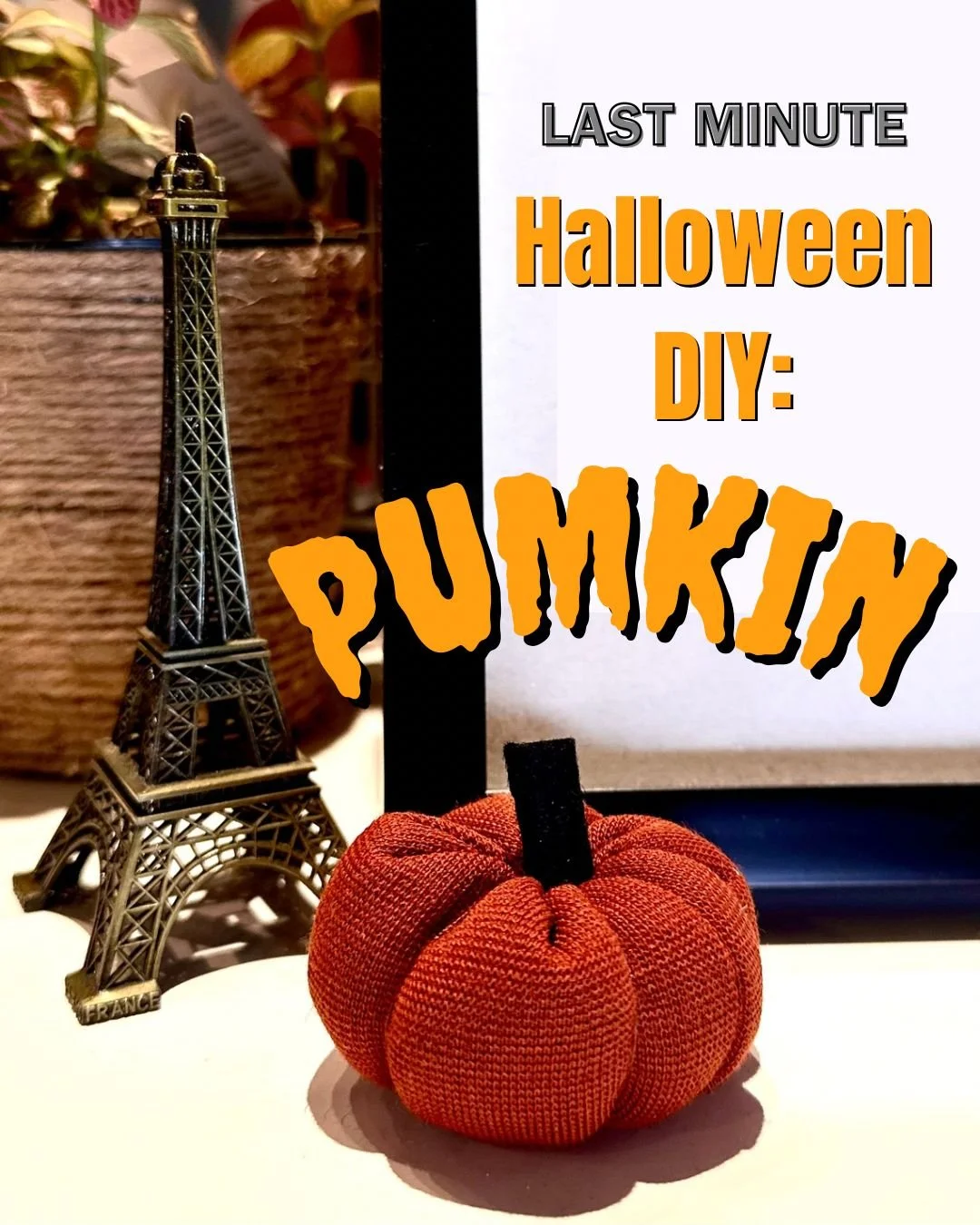 A small, orange fabric pumpkin craft decorated with a black stem, placed next to a miniature Eiffel Tower figurine, with a background of wooden and floral elements, and a sign with text about last-minute Halloween DIY pumpkin craft ideas.