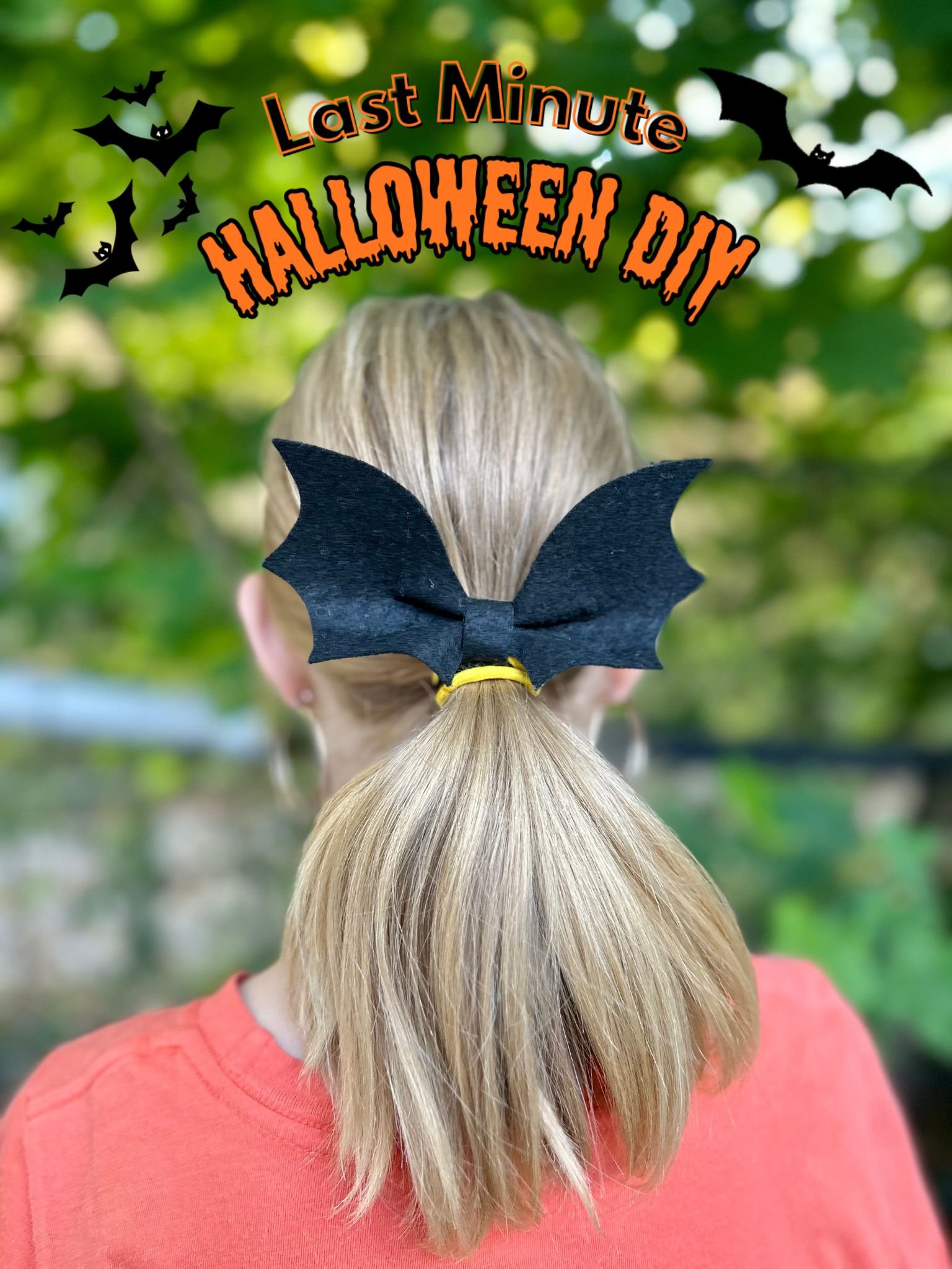Back view of a person with blonde hair tied in a ponytail, wearing black bat-shaped hair accessory and an orange shirt. The background shows green, blurred foliage. The image has Halloween-themed text and graphics at the top reading 'Last Minute Halloween DIY' with bats flying.