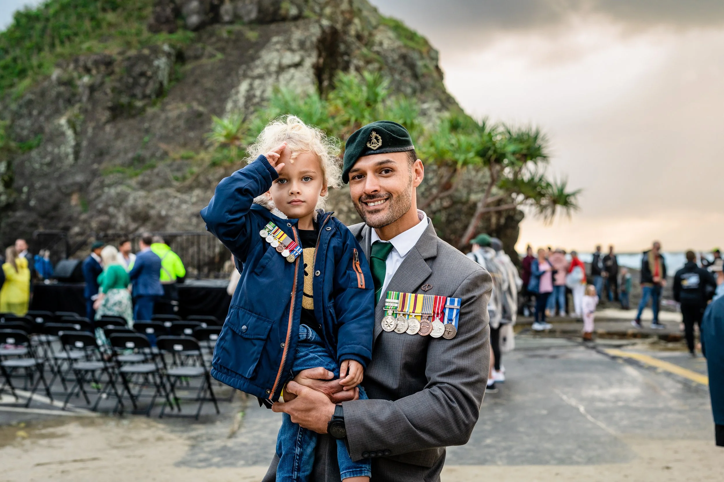Man and his child at an Anzac Day service