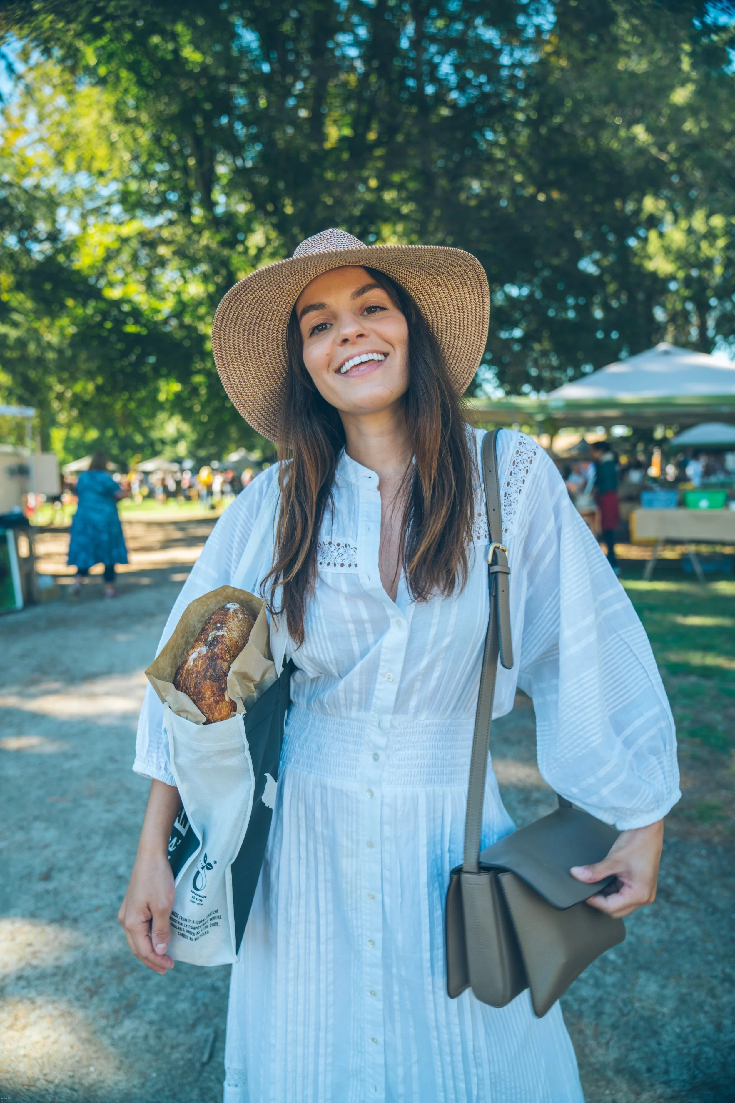 Carrie Rad exploring the Hawke’s Bay Farmers’ Market in Hastings, New Zealand, with fresh artisan bread at one of the country’s largest farmers’ markets and a showcase of Hawke’s Bay food culture and local produce.
