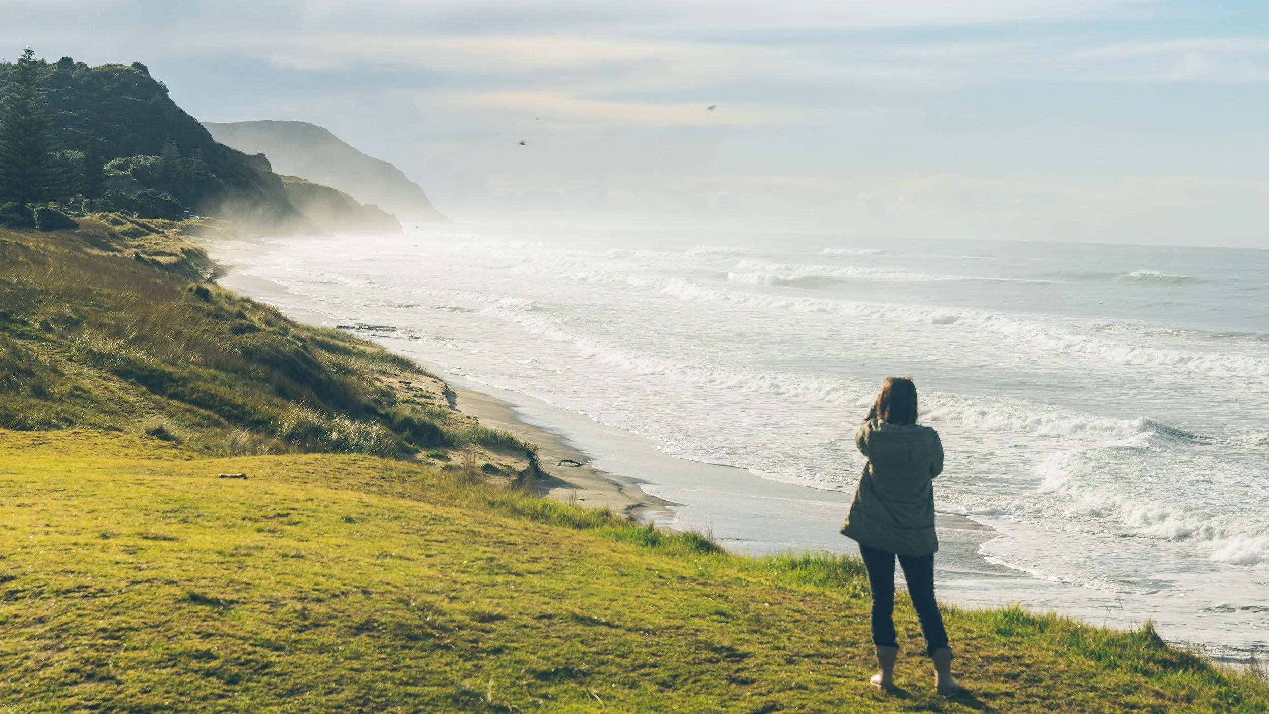 Carrie Rad overlooking the waves and surf at Waimea Beach in Gisborne, on New Zealand’s East Coast, one of the first places in the world to see the sunrise.