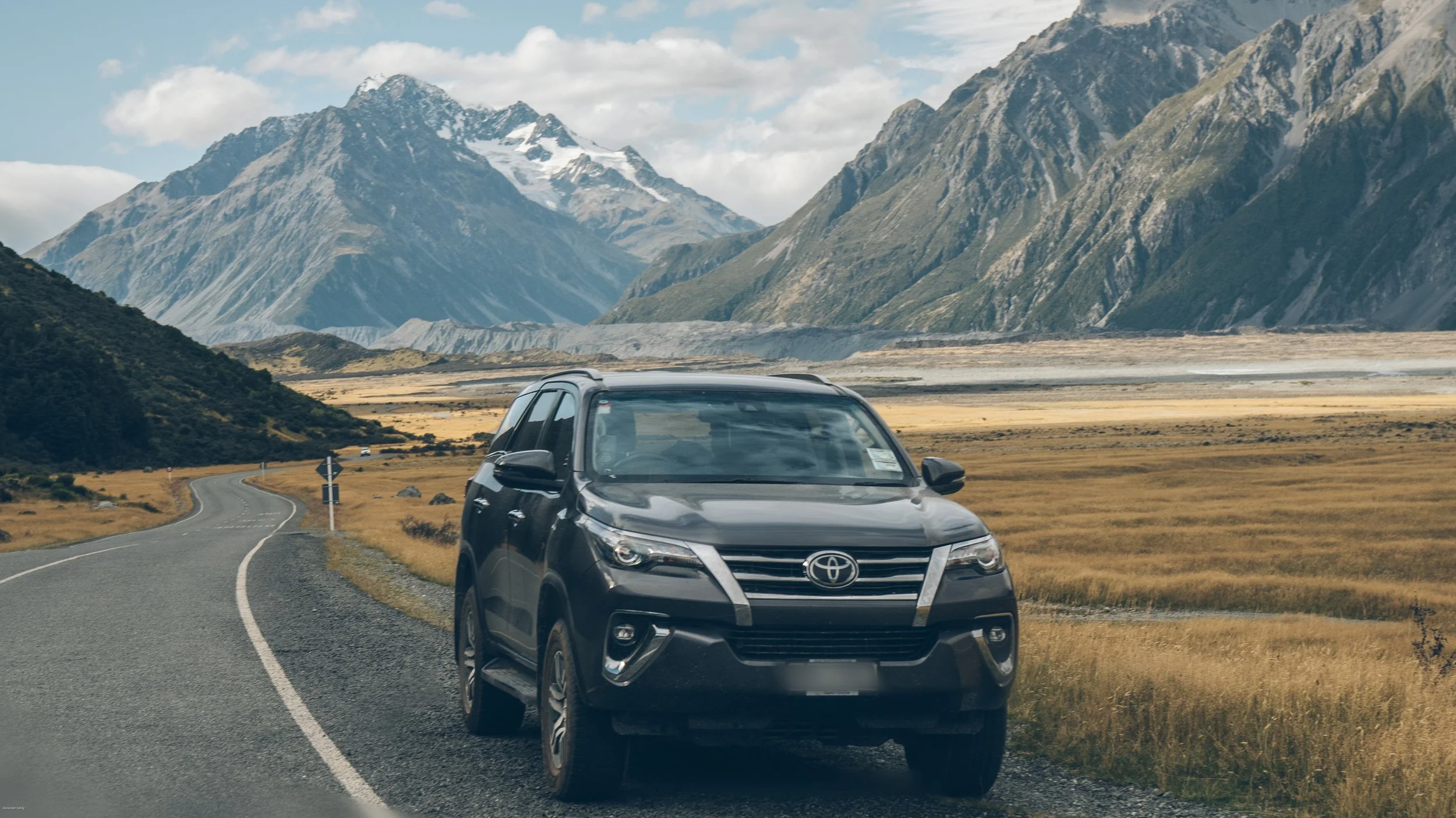 Driving to Aoraki / Mount Cook National Park along State Highway 80, one of New Zealand's most scenic road trips, with dramatic alpine peaks, glacial valleys, and breathtaking South Island landscapes.